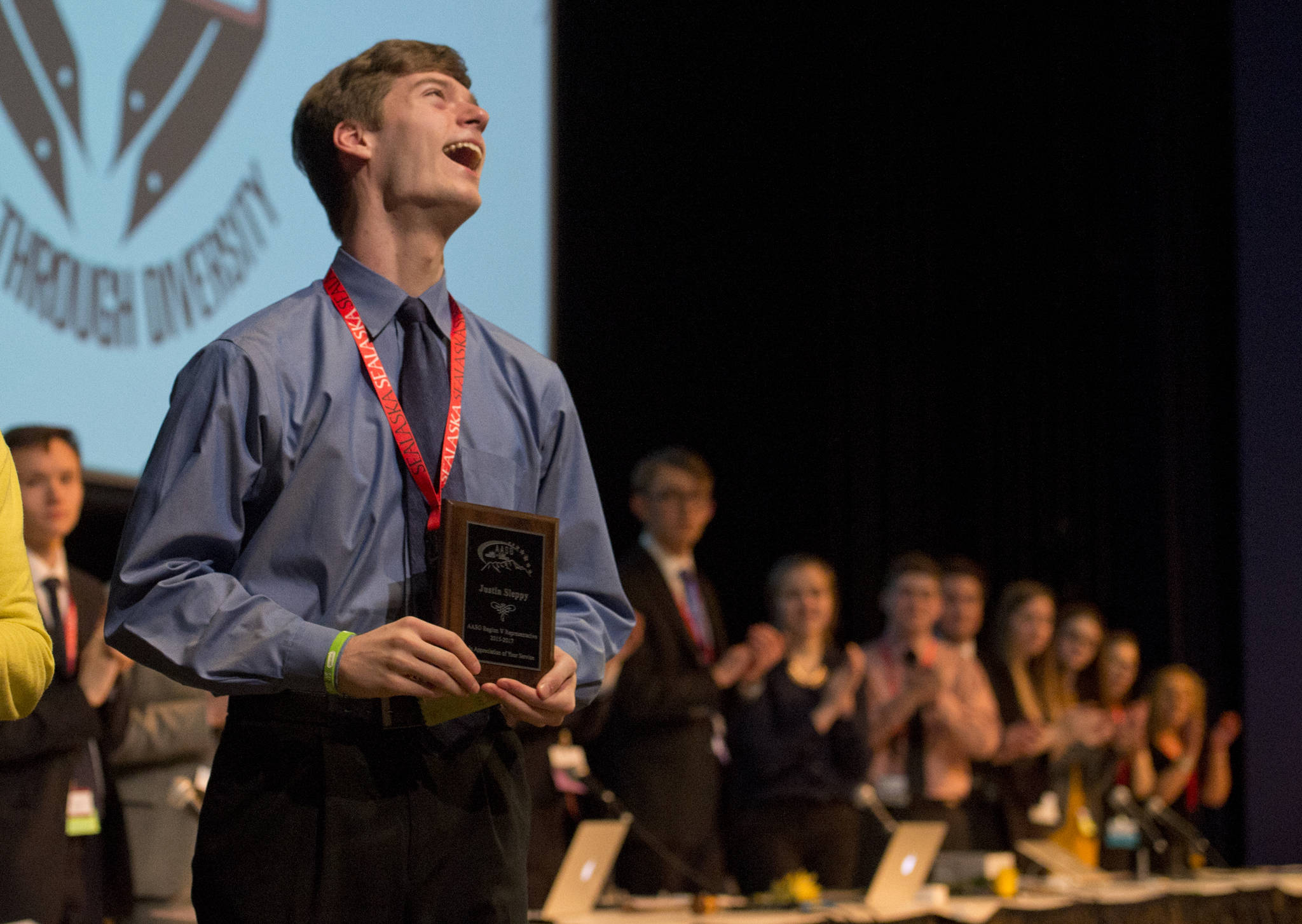 Justin Sleppy, a senior at Thunder Mountain High School, reacts to receiving a National Student Council Leader Award during the final day of the Alaska Association of Student Governments Spring 2017 Conference at TMHS on Wednesday. (Michael Penn | Juneau Empire)