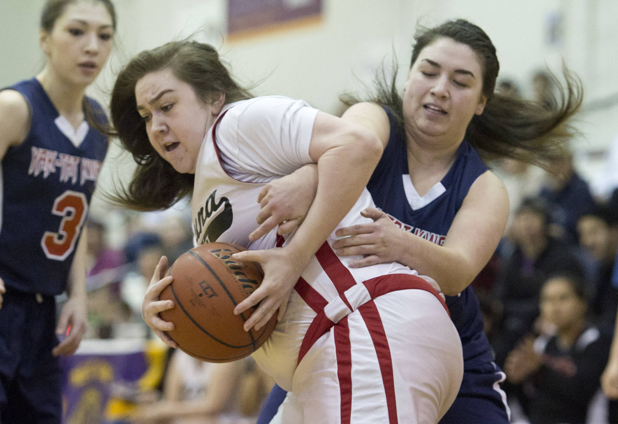 Yakutat’s Nadine Fraker attempts to steal the ball from Hoonah’s Mariah Martin in their Womens Bracket game in the Lions Club’s Gold Medal Basketball Tournament at Juneau-Douglas High School on Friday, March 24, 2017. Hoonah won 56-53. (Michael Penn | Juneau Empire)