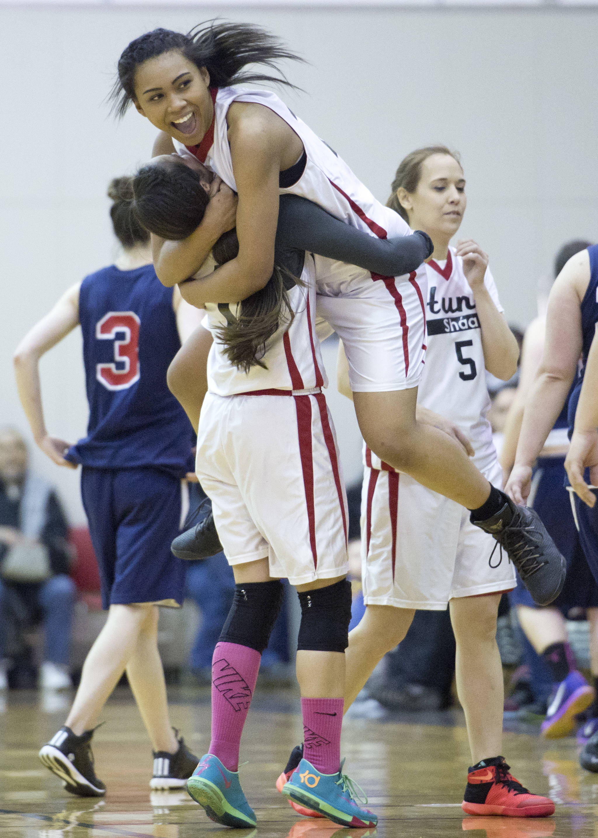Hoonah’s Melissa Fisher lifts teammate Taryn White in celebration of their win over Yakutat in their Womens Bracket game in the Lions Club’s Gold Medal Basketball Tournament at Juneau-Douglas High School on Friday, March 24, 2017. Hoonah won 56-53. (Michael Penn | Juneau Empire)