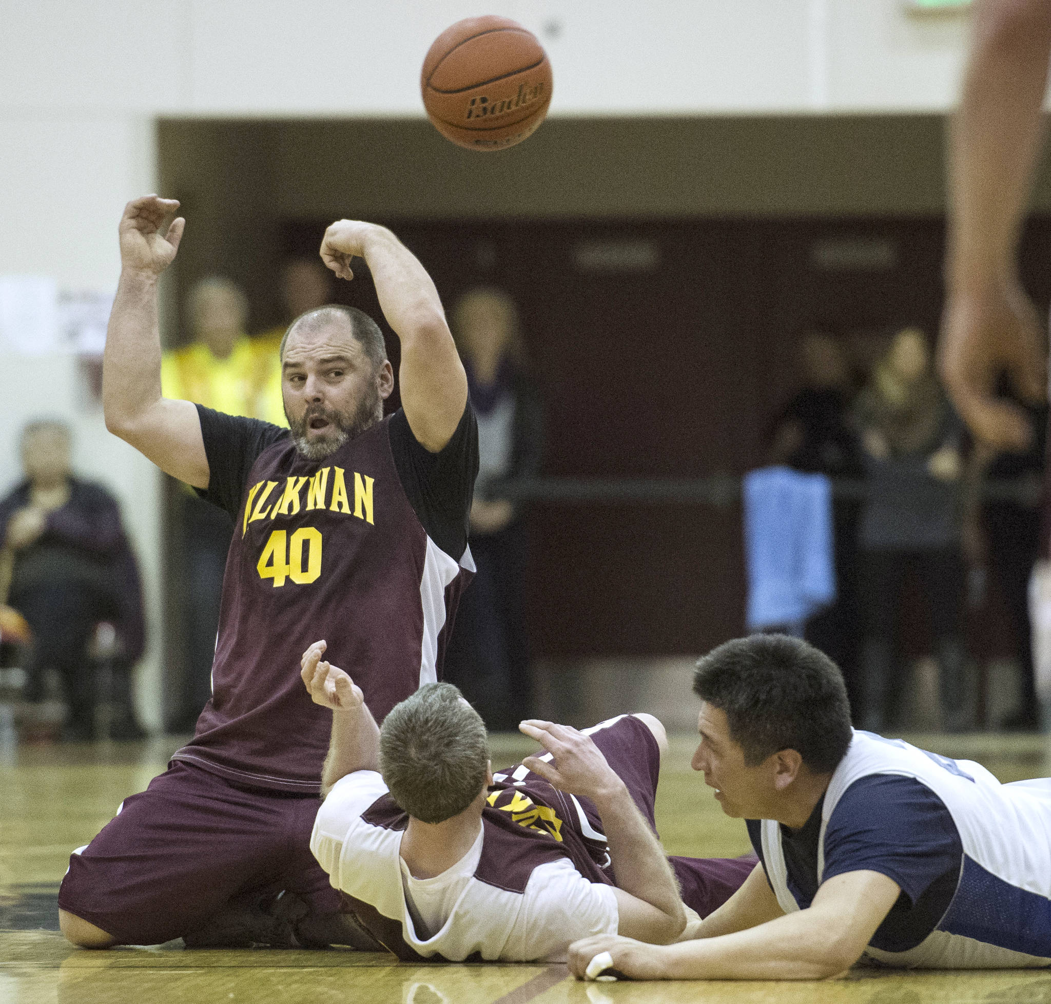 Klukwan’s Stuart DeWitt, right, makes a no-look pass against Juneau’s James Gang in the C Bracket finals of the Lions Club’s 71st Gold Medal Basketball Tournament at Juneau-Douglas High School on March 25, 2017. Klukwan won in triple overtime 107-97. (Michael Penn | Juneau Empire)