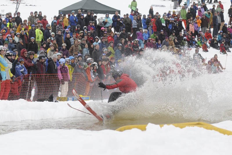 A 2012 Slush Cup skier tries to maintain his balance before hundreds of curious onlookers. The event is a popular spectator sport as many contestants endure comical crashes into the water. Courtesy Eaglecrest Ski Area.