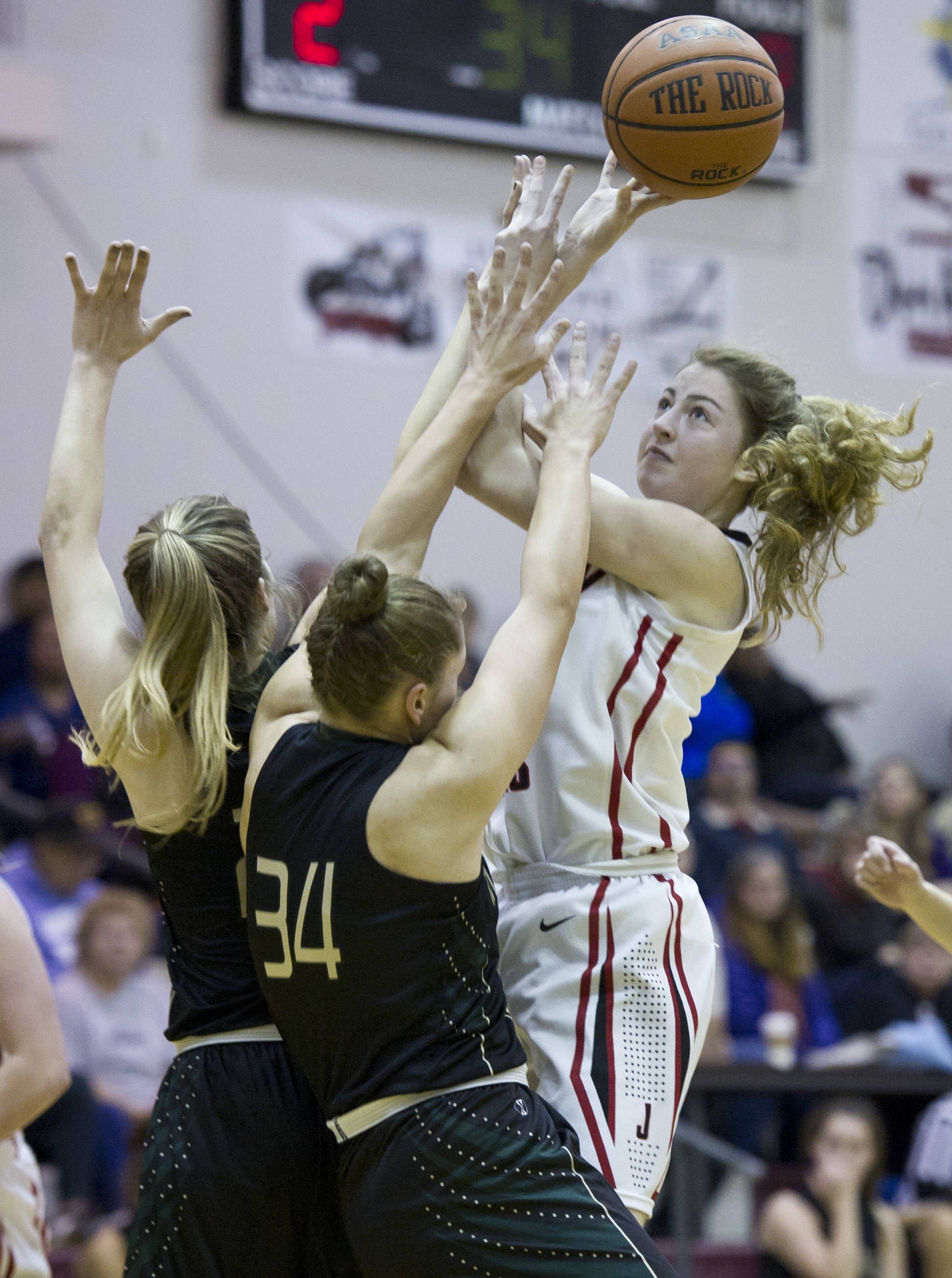 Juneau-Douglas’ Kendyl Carson puts up a shot against Marysville’s Maddy Grandbois, center, and Carley Wika during the Capital City Classic at JDHS on Friday, Dec. 30, 2016. (Michael Penn | Juneau Empire File)