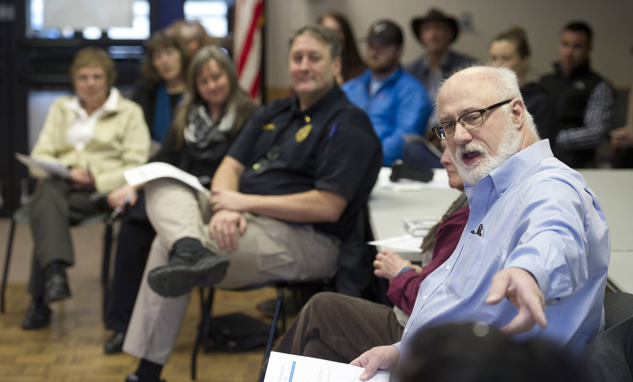 Robert Sewell introduces topics during a Douglas Island Neighbors Association meeting at the Douglas Public Library on Tuesday. (Michael Penn | Juneau Empire)