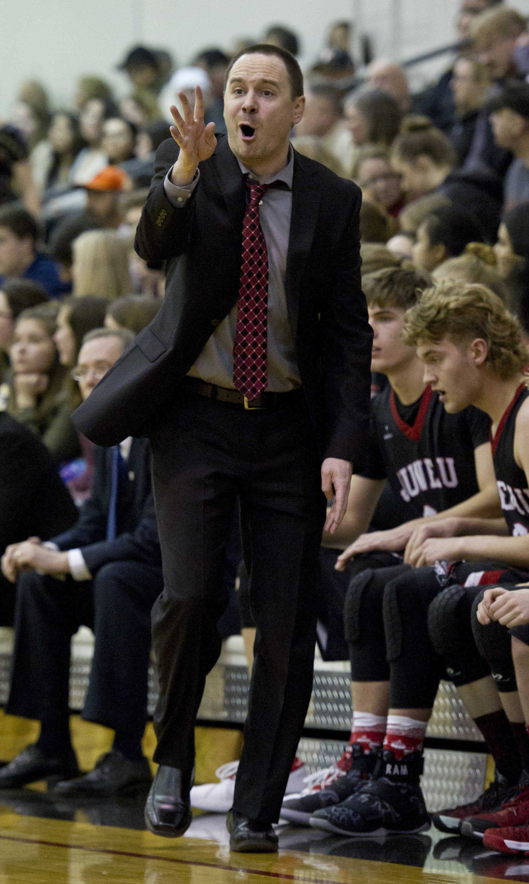Juneau-Douglas’ head coach Robert Casperson yells out instructions as his team plays against Dimond High School in the Capital City Classic at JDHS on Friday, Dec. 30, 2016. (Michael Penn | Juneau Empire File)