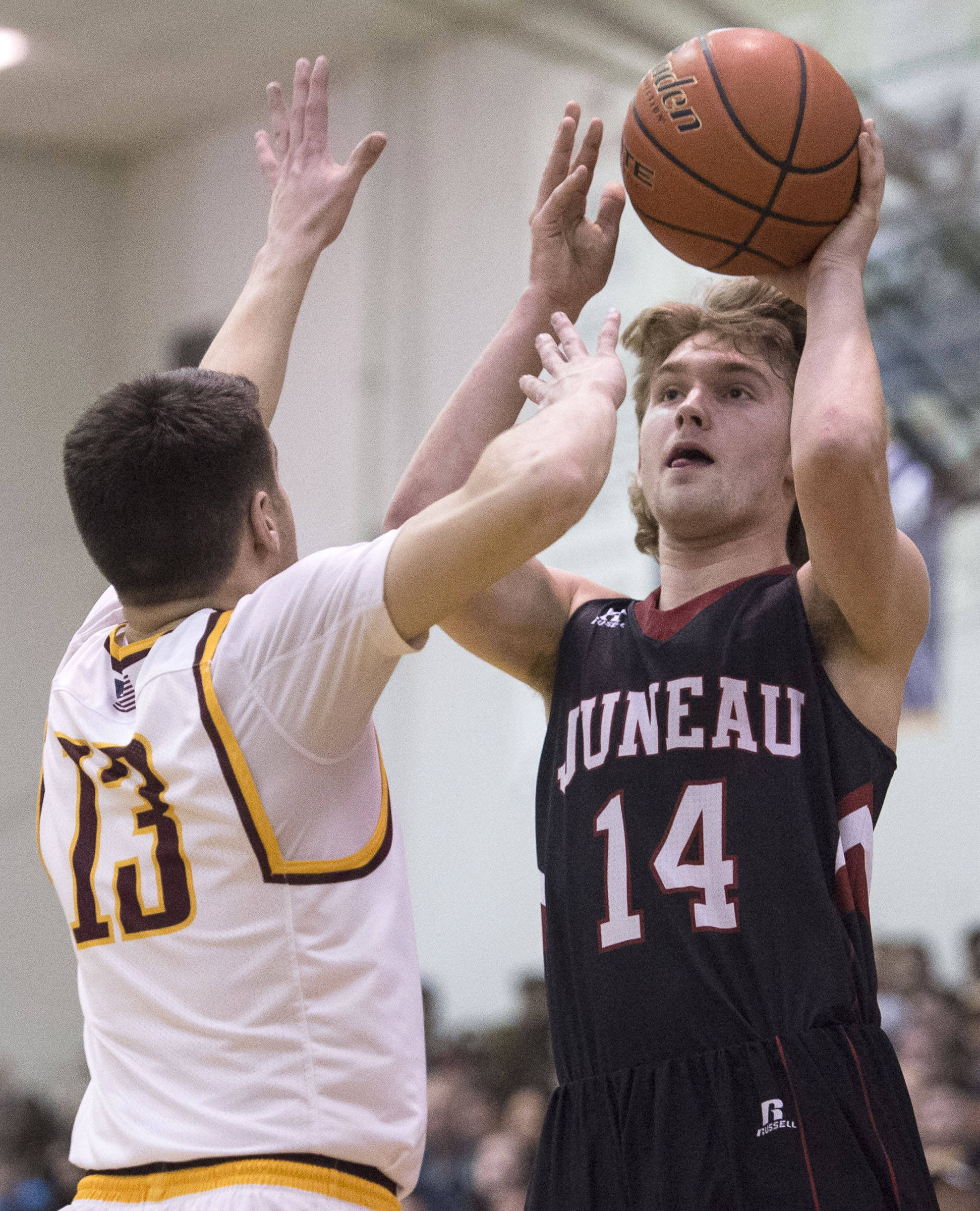 Juneau-Douglas’ Kasey Watts shoots against Ketchikan’s Jake Smith during the Region V Basketball finals at JDHS on Friday, March 10, 2017. (Michael Penn | Juneau Empire File)
