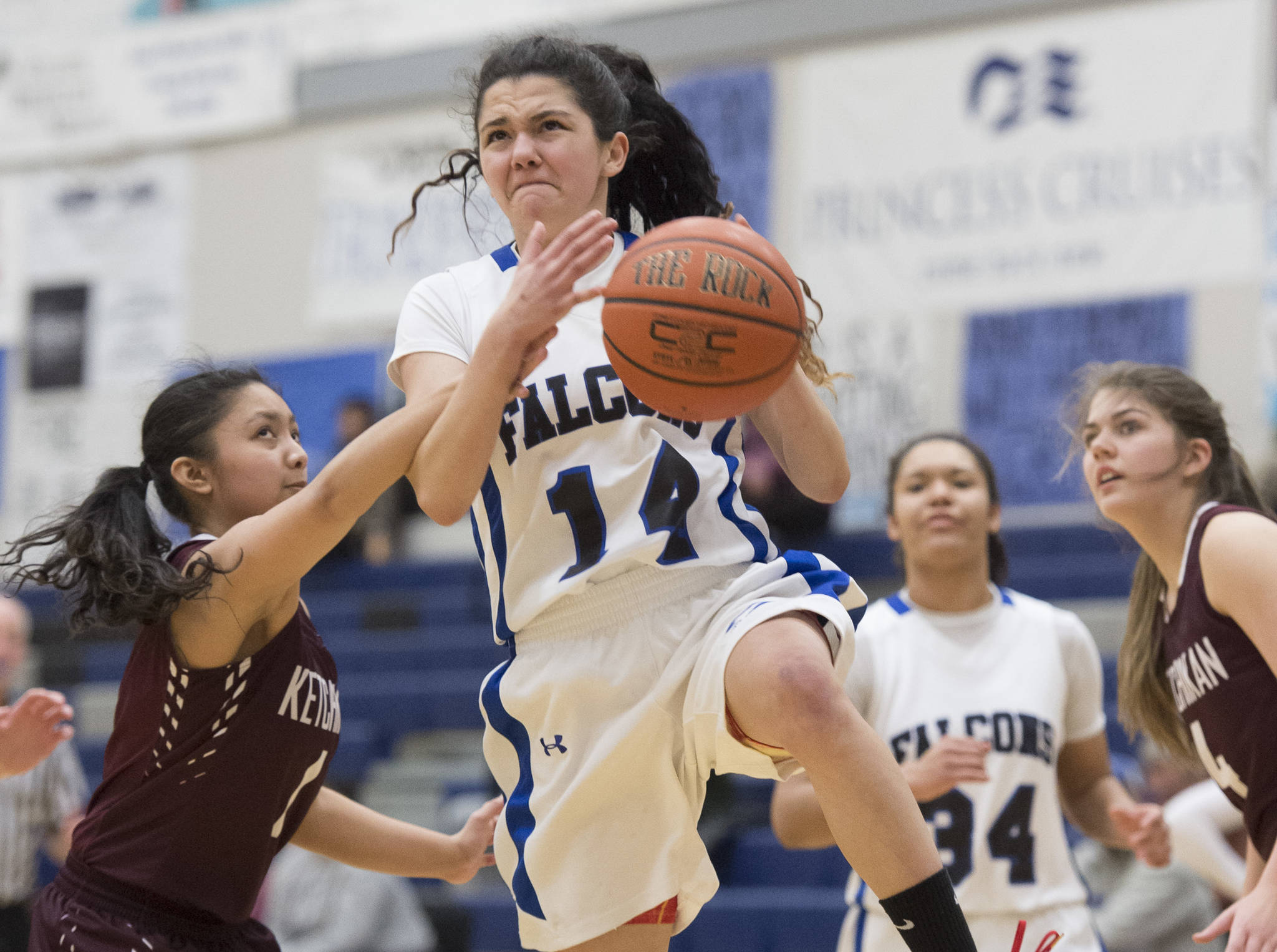 Thunder Mountain&rsquo;s Charlee Lewis, center, is fouled on the way to the basket by Ketchikan&rsquo;s AJ Dela Cruz at TMHS on Thursday, Feb. 23, 2017. Ketchikan won 55-26. (Michael Penn | Juneau Empire)