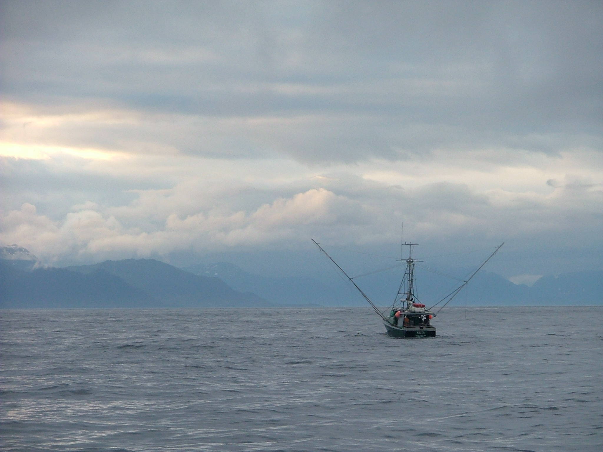 A troller with Yakobi Island in the background, a picture of the area written about in “The Mysteries of Yakobi Island” from “Haunted Inside Passage.” Photo by Bjorn Dihle.