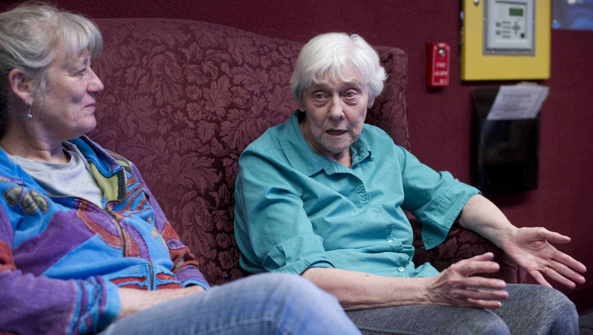 Juneau Pioneer Home resident Phyllis Woodman, right, talks about the grief caused by the Legislature’s proposed budget cuts to the home’s residents and staff on Tuesday, April 11, 2017. A resident of the home for four years, Woodman was being visited by Carol Schriver, left. (Michael Penn | Juneau Empire)