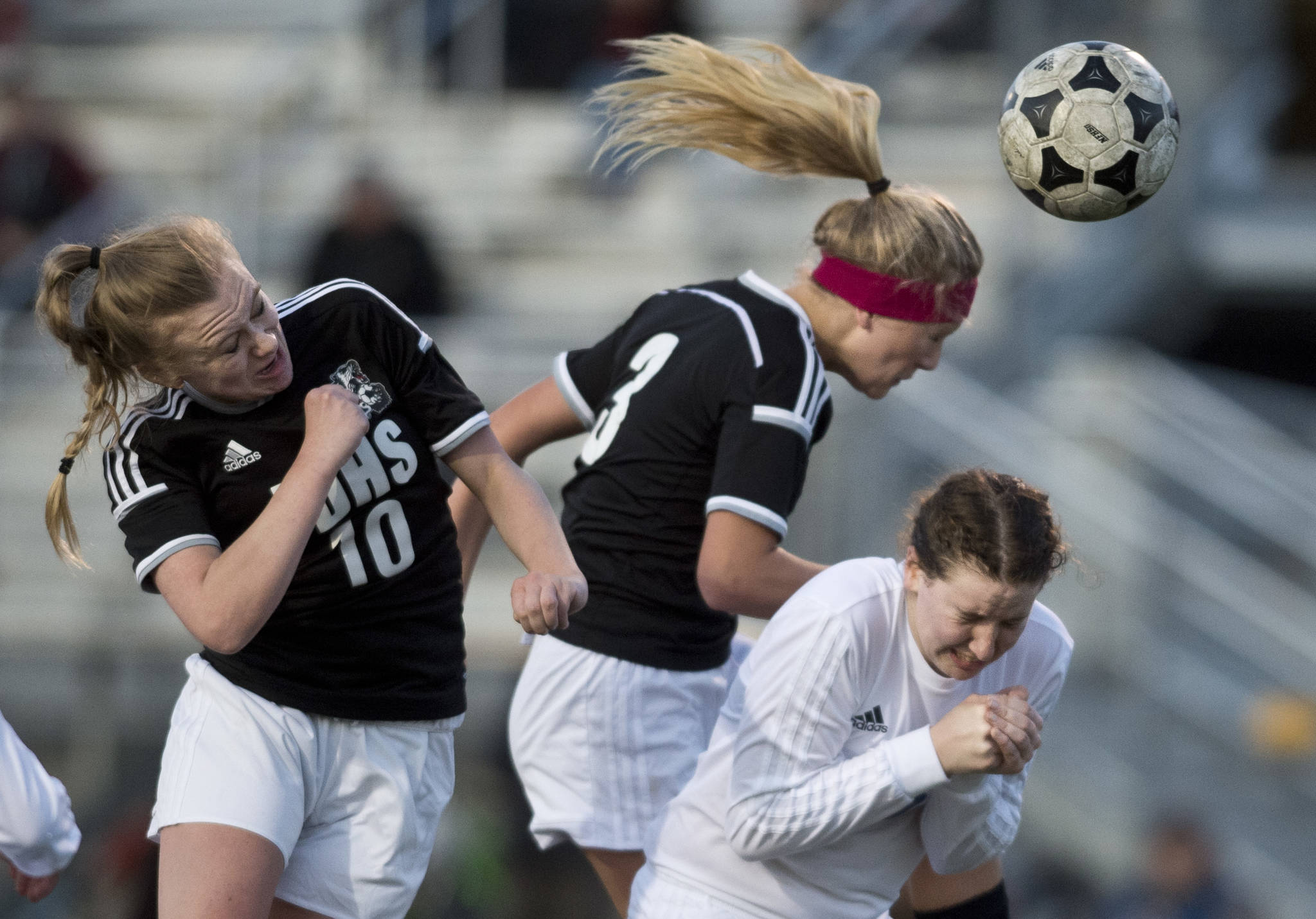 Juneau-Douglas’ Erika Holst, left, and Michaela Bentley attempt to score off a corner kick against Thunder Mountain’s Meghan Penrose during their match at TMHS on Tuesday, April 11, 2017. Juneau-Douglas won 1-0. (Michael Penn | Juneau Empire)