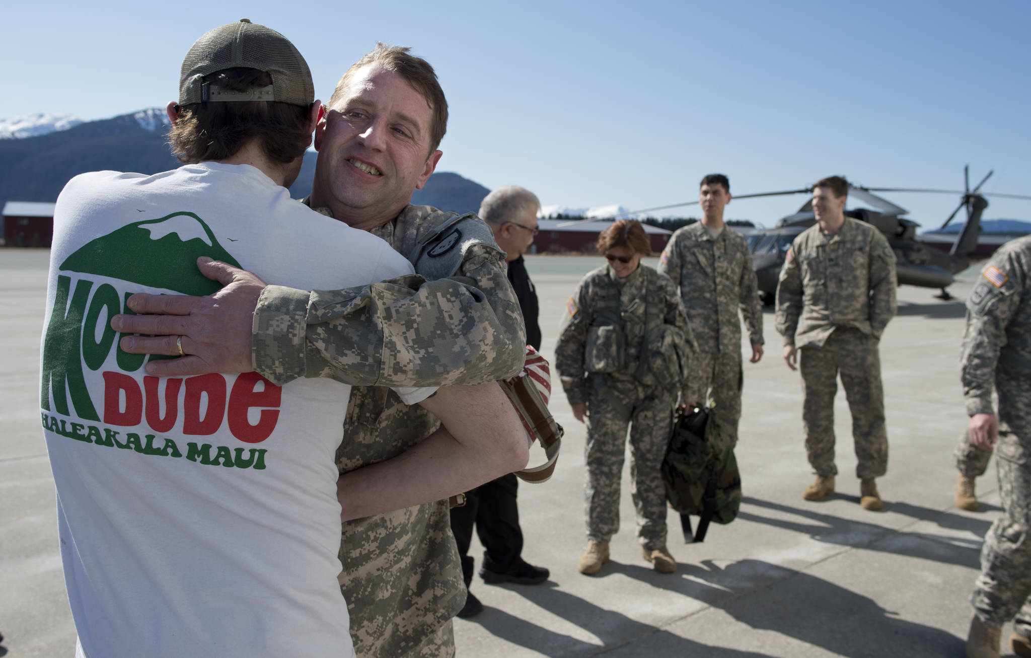 Alaska Army National Guard Chief Warrant Officer 4 Mike Michaud receives a hug from his son, Kevin, at the Juneau International Airport after taking his last flight in the Guard’s Black Hawk helicopter on Wednesday.  Michael Penn | Juneau Empire