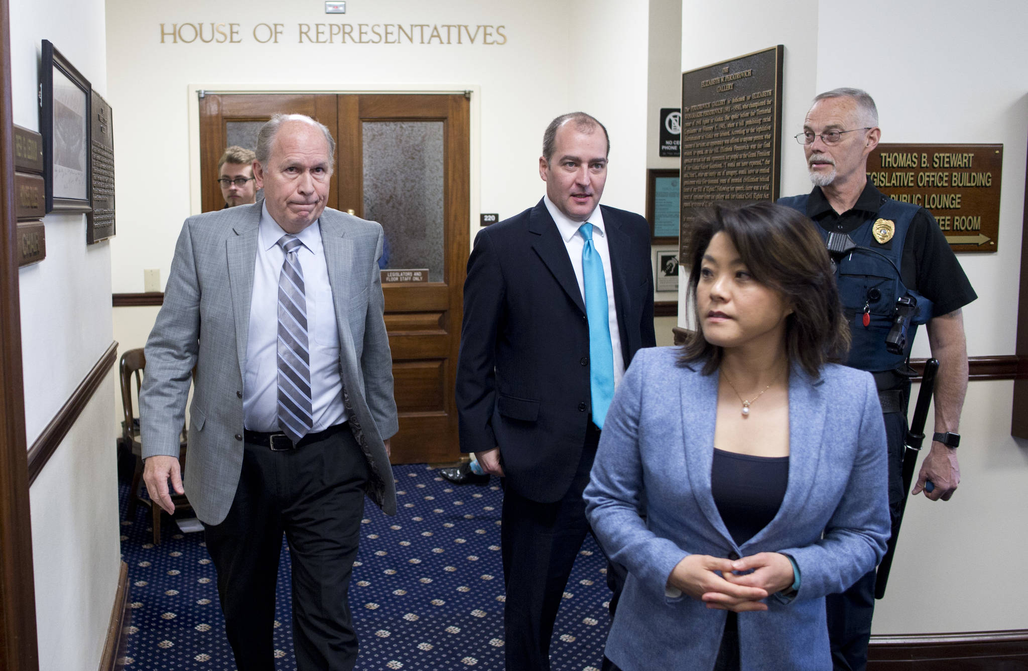 Gov. Bill Walker leaves the gallery of the Alaska House of Representatives with his legislative liaison Darwin Peterson, center, and Communication Director Grace Jang after watching the House passed their version of Senate Bill 26 on Wednesday, April 12, 2017. The bill would draw from the earnings of the Alaska Permanent Fund to address Alaska’s $2.7 billion funding gap, and cap the Permanent Fund Dividend at $1,250 for the next two years. (Michael Penn | Juneau Empire)