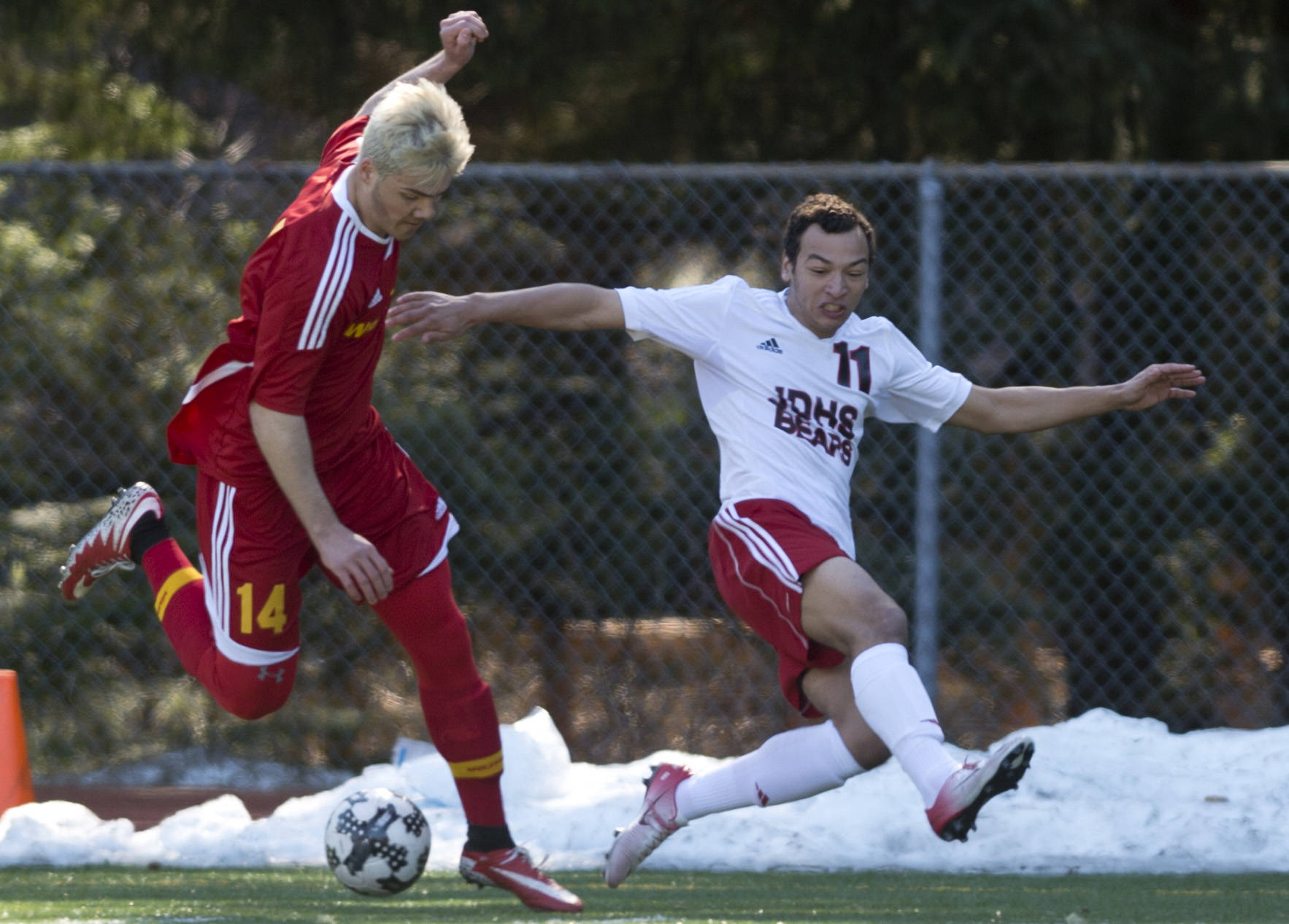 Juneau-Douglas&rsquo; Ben Carter competes against West Valley&rsquo;s Ricky Stanton at Adair-Kennedy Memorial Field on Friday. (Michael Penn | Juneau Empire)