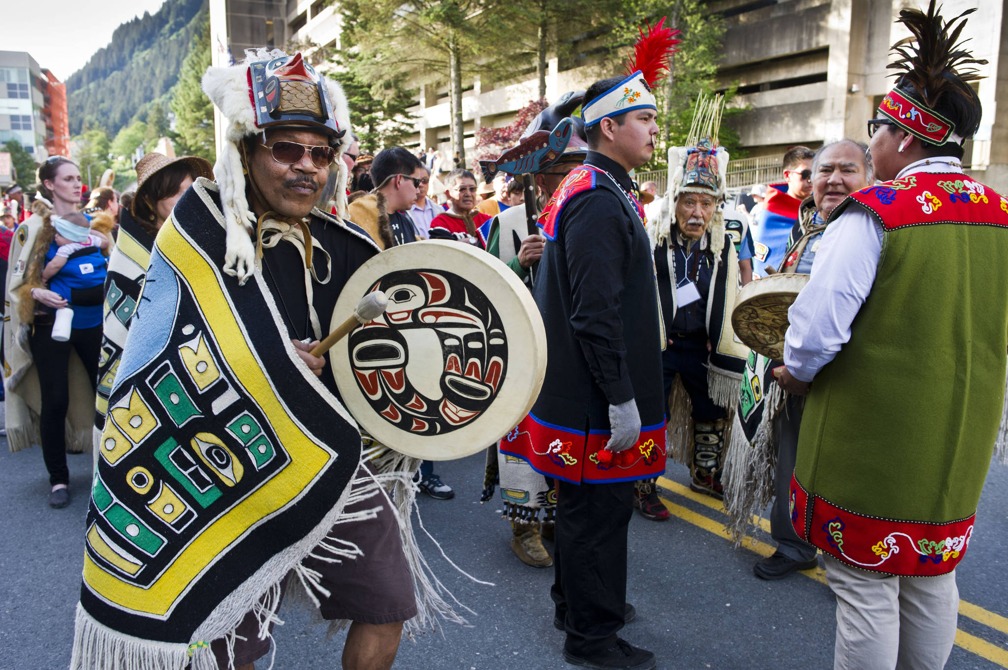 Fifty Tlingit, Haida, and Tsimshian groups dressed in traditional regalia take part in the Grand Entrance Processional down Willoughby Street from Elizabeth Peratrovich Hall to Centennial Hall to kickoff the four days of Celebration in June 2016. (Michael Penn | Juneau Empire file)
