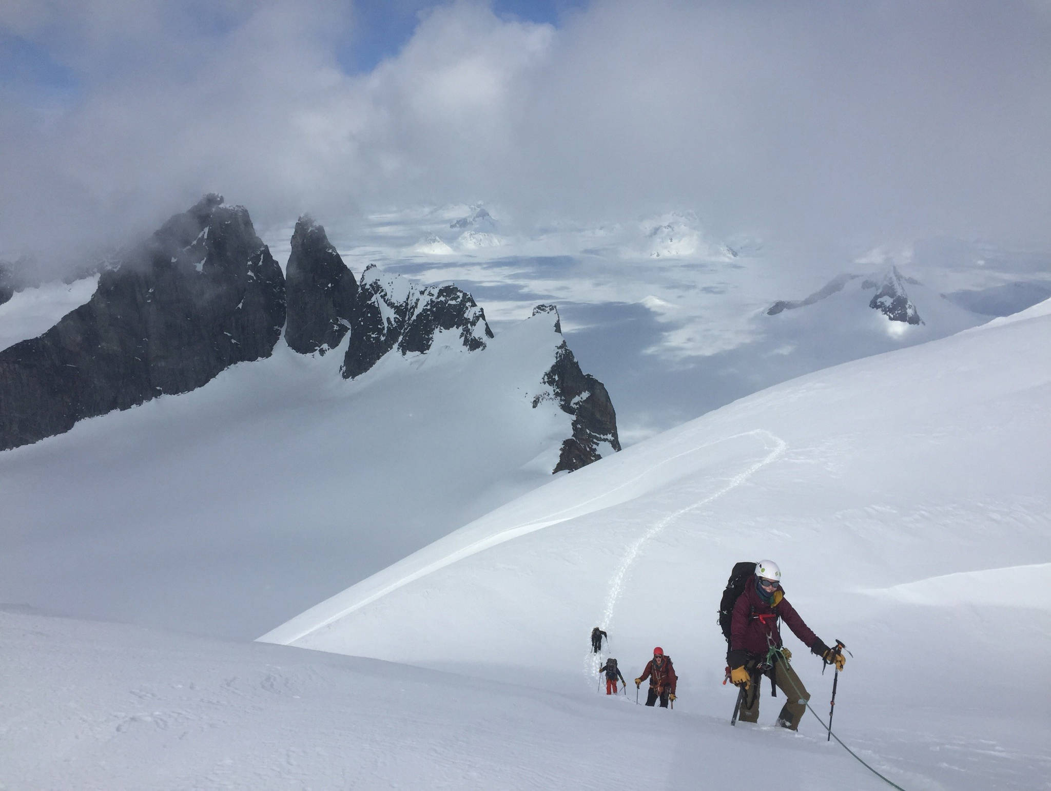 Katie McCaffrey approaches the Summit of Emperor Peak on April 15, the Taku Towers are behind. (Photo by Forest Wagner)