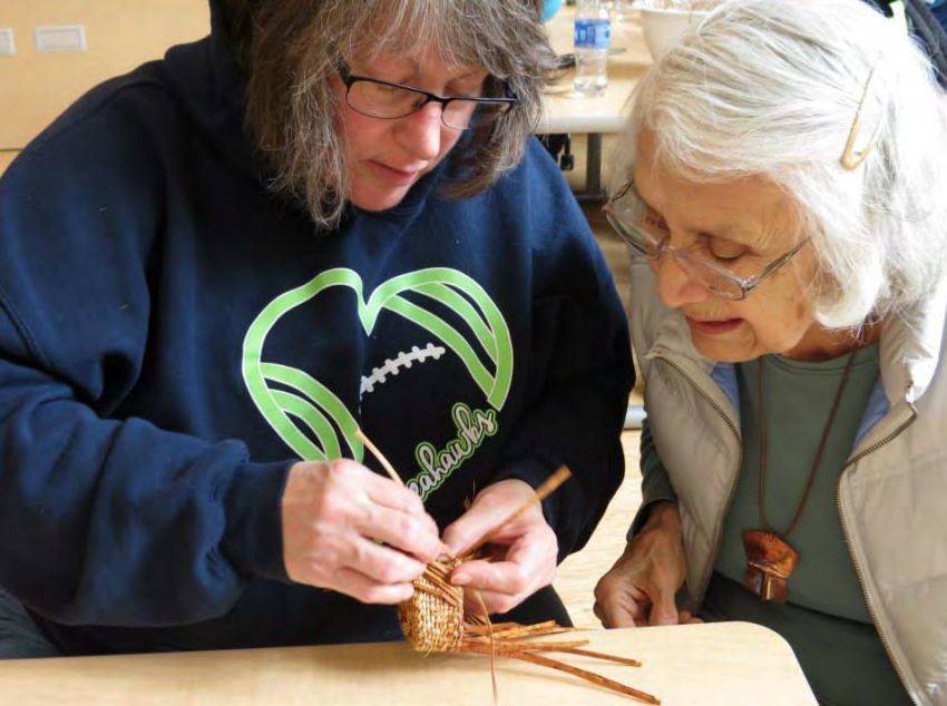 Haida weaver Delores Churchill, right, has become a teacher over the years, passing along artistic techniques and cultural knowledge to younger generations. (Photo courtesy of the Central Council of Haida and Tlingit Tribes of Alaska)