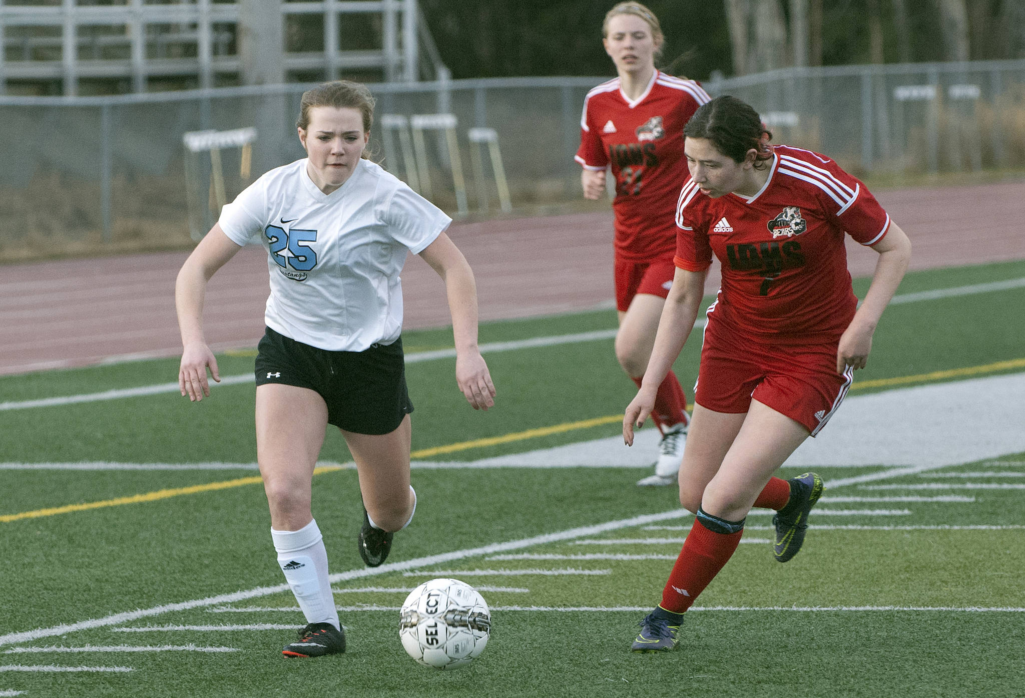Chugiak&rsquo;s Reyna Moore drives past Juneau&rsquo;s Elissa Koyuk During the Crimson Bears&rsquo; 2-0 nonconference girls&rsquo; soccer win on Thursday, April 27, 2017 at Ed Blahous Field in Chugiak. (Matt Tunseth | Chugiak-Eagle River Star)