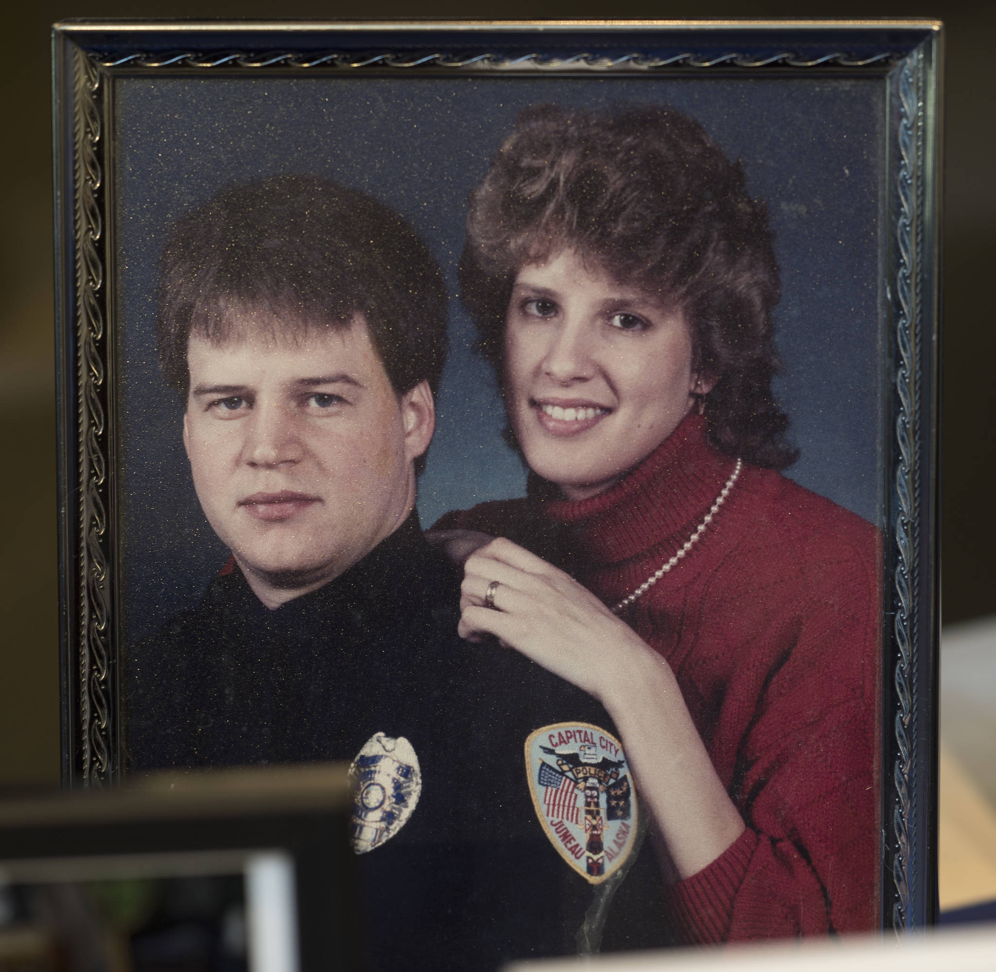 A picture on display of Juneau Police Officer Karl William Reishus and his wife, Sue, at a remembrance ceremony at the Father Andrew P. Kashevaroff Building on Thursday, May 4, 2017, on the 25th anniversary of his death. (Michael Penn | Juneau Empire)