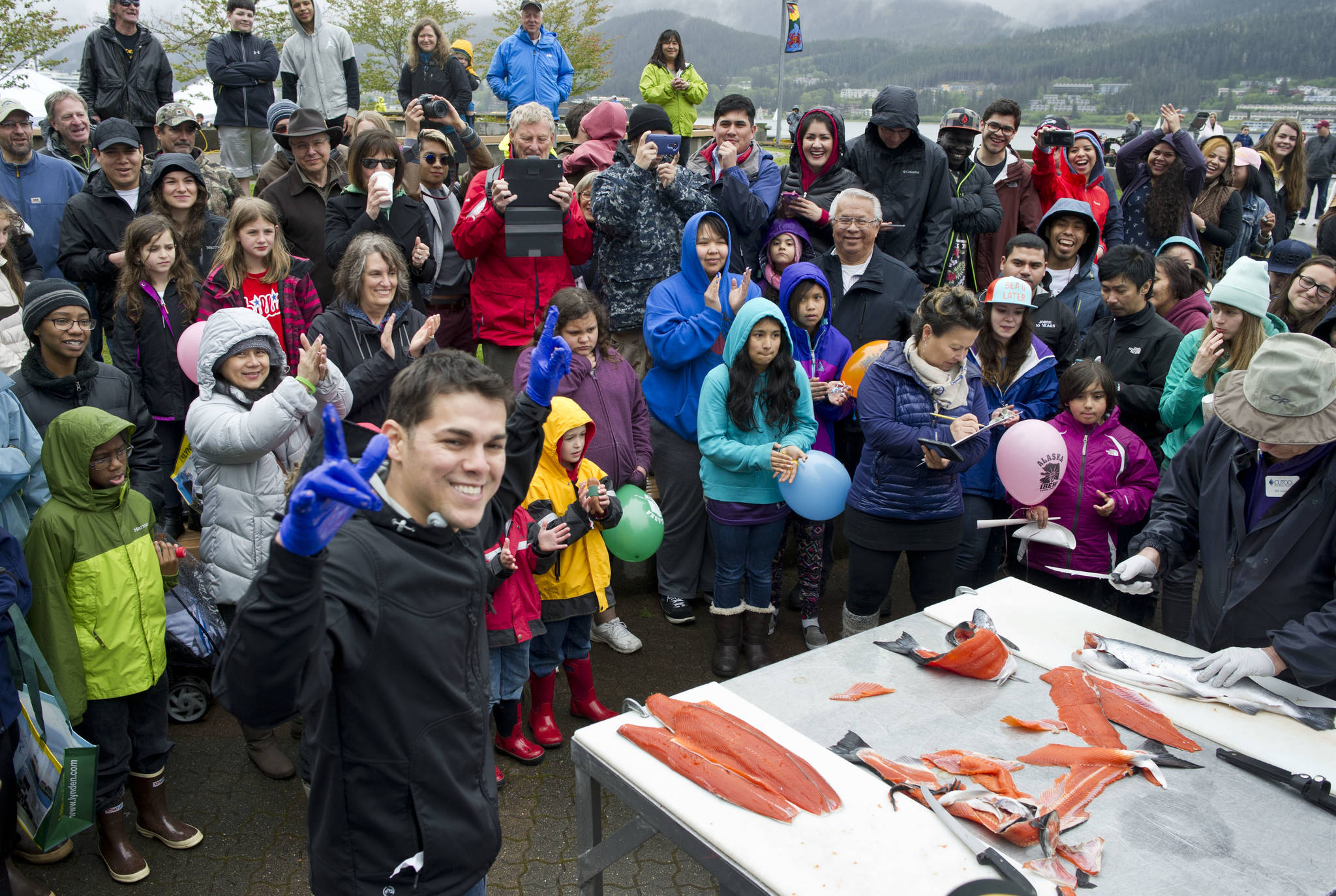 Irat De La Mora acknowledges the crowd after showing his talent for slicing up coho salmon at the Juneau Maritime Festival at Marine Park in Juneau on Saturday, May 7, 2016. (Michael Penn | Juneau Empire File)