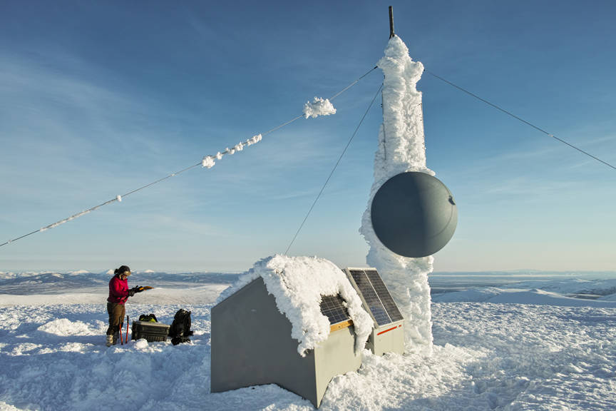 Alaska Earthquake Center field technician Dara Merz services a seismic station in the White Mountains in 2014. (Photo by Ian Dickson, courtesy Alaska Earthquake Center)