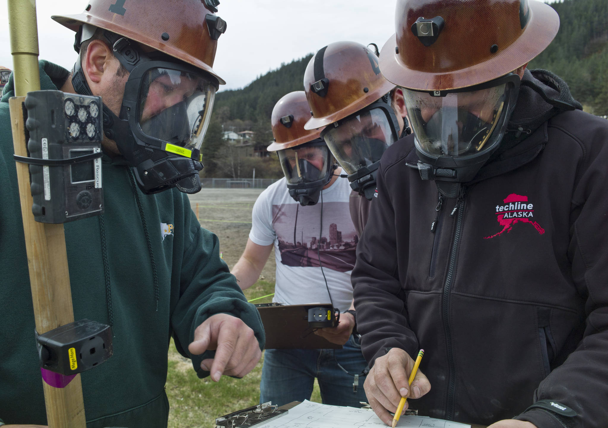 Eddie Petrie, left, talk with Mike Walters, right, as Jason Cameron and Alan Gordon, listen during Coeur’s Kensington Mine Rescue team practice at Savikko Park on Tuesday, May 2, 2017. The Kensington team and one from Hecla’s Green Creek Mine will compete next week at the Central Mine Rescue Competition in Kellogg, Idaho. (Michael Penn | Juneau Empire)