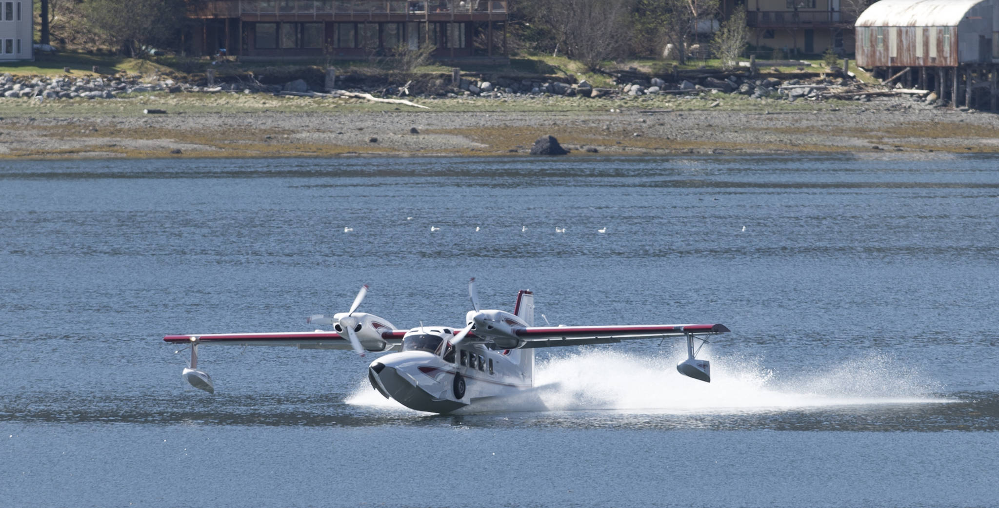 Ross Mahon and Ben Ellison touchdown in Juneau downtown harbor in a plane they’re calling a Gweduck (misspelled on purpose) on Thursday, May 4, 2017. A “new twist on an old design,” the plane looks like an vintage aircraft but is made with modern materials. It began as a side project for the two aeronautical engineers from Seattle and is now a reality. It made the stop in Juneau on Thursday on its way to Anchorage. (Michael Penn | Juneau Empire)
