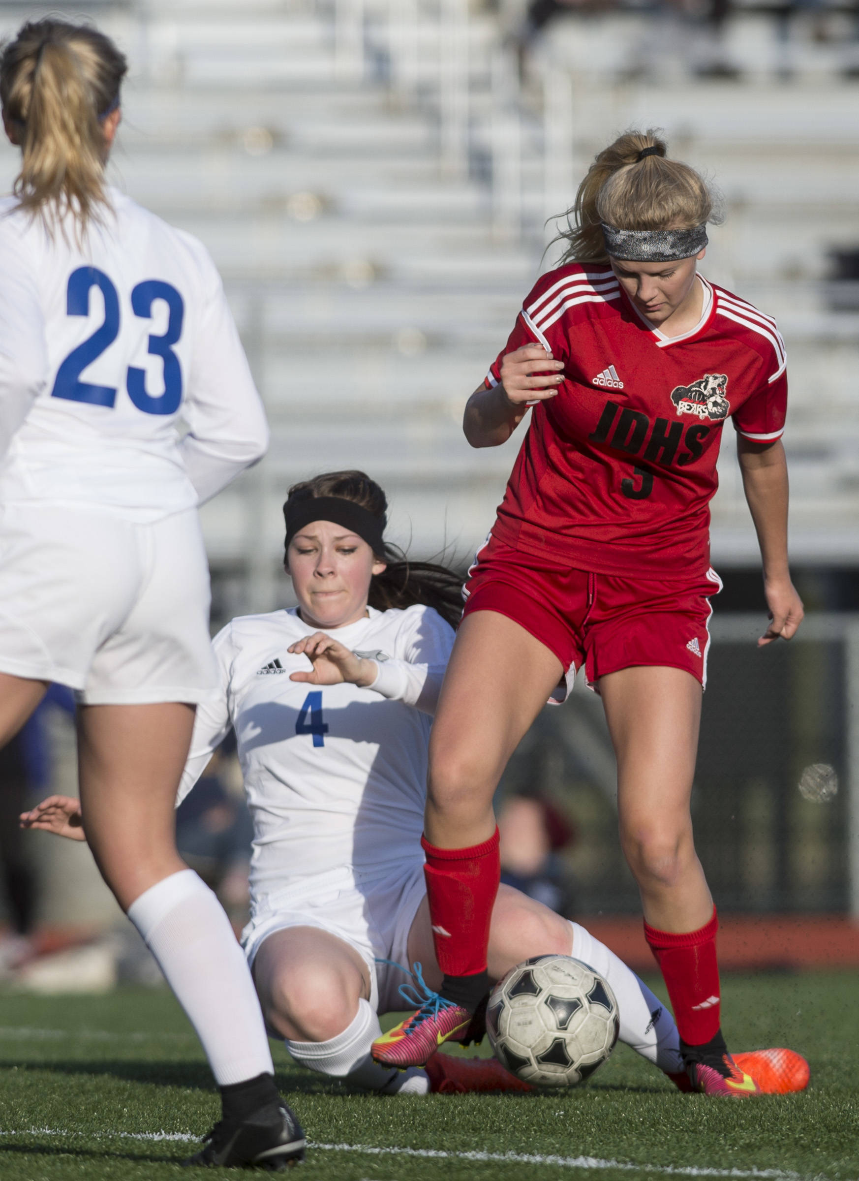 Juneau-Douglas’ Michaela Bentley takes the ball from Thunder Mountain’s Azure Briggs at TMHS on Tuesday, May 9, 2017.(Michael Penn | Juneau Empire)