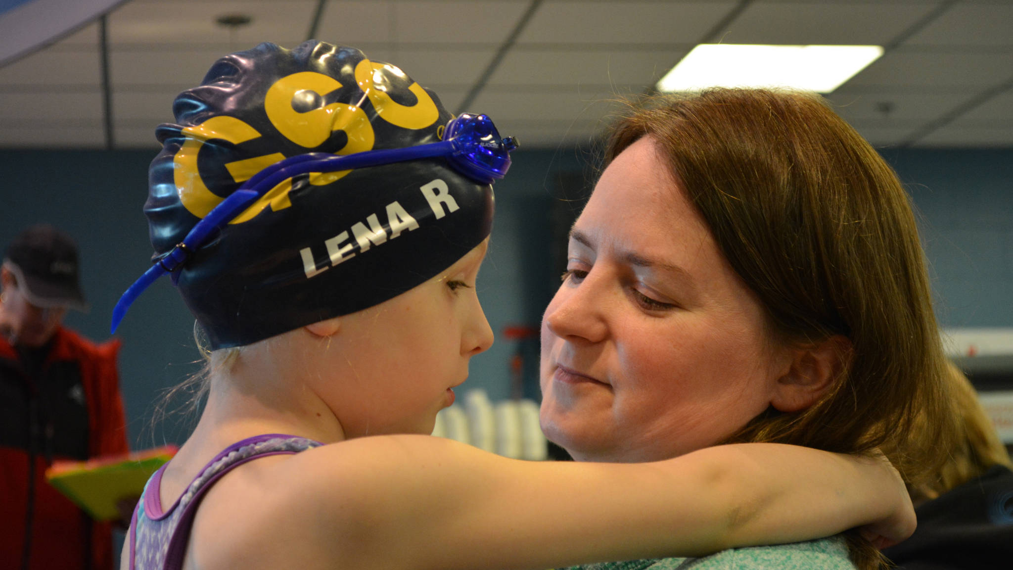 Lena Rasmussen gets some pre-race encouragement from her mother inside the Dimond Park Aquatic Center, Saturday, May 6. Around 60 kids competed in the long and short courses for no fee. (Photo courtesy Michelle Rochette)