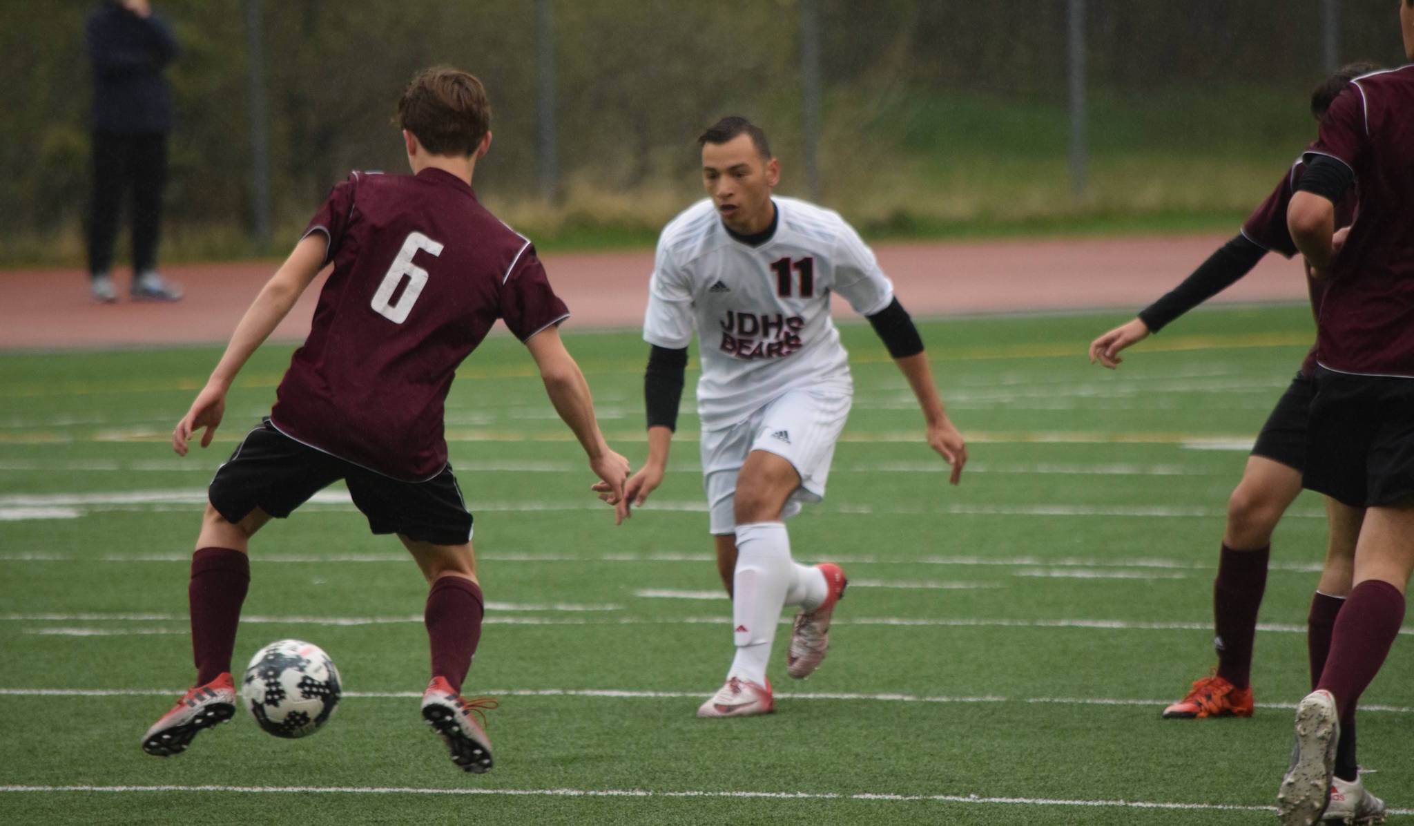 Juneau-Douglas&rsquo; Ben Carter pressures Ketchikan&rsquo;s Brayden Linne Friday at Adair-Kennedy. JDHS won 1-0. (Nolin Ainsworth | Juneau Empire)