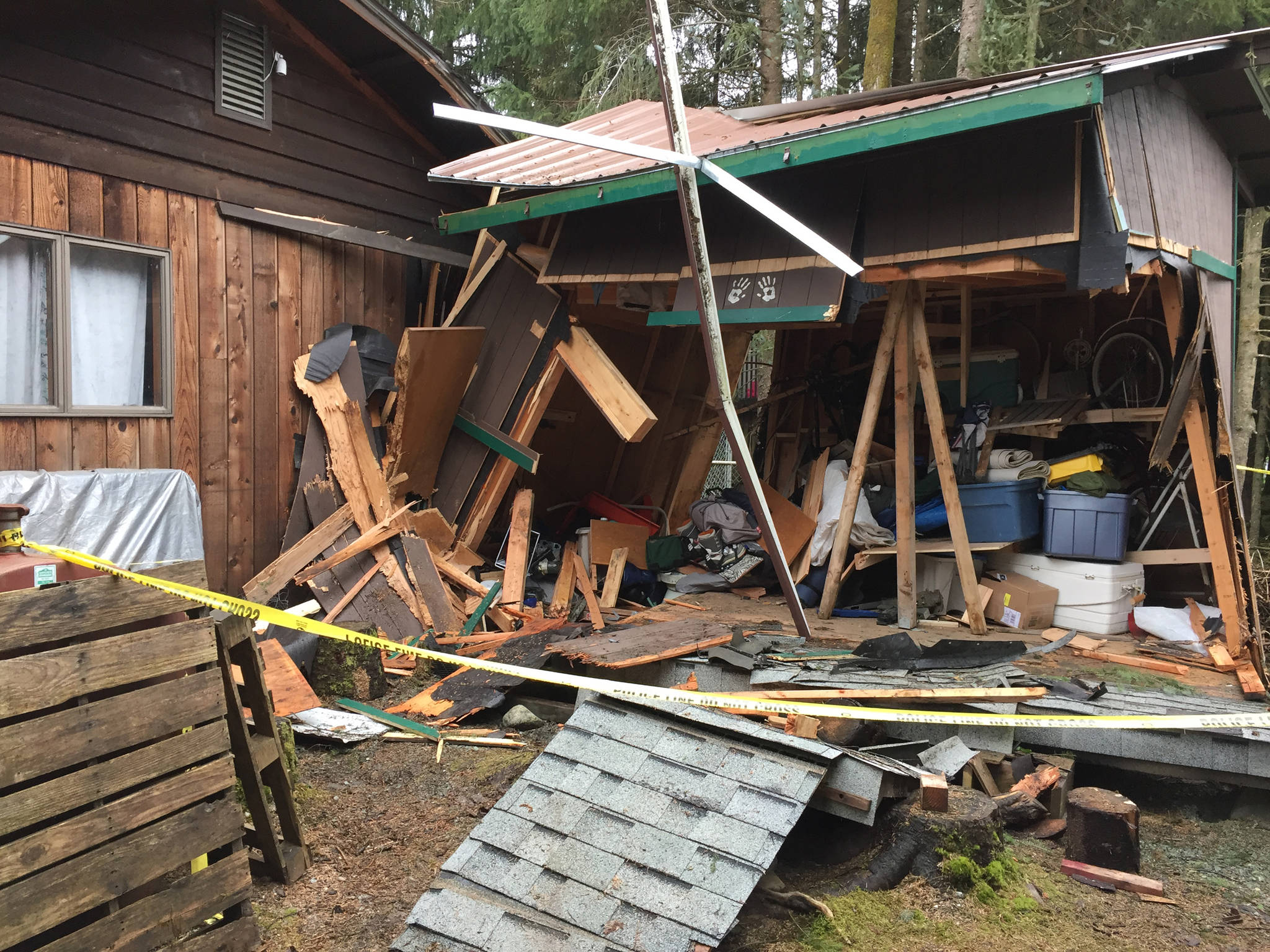 A shed is destroyed outside a Mendenhall Loop home that was hit by a drunk driver on Friday evening. (Kevin Gullufsen | Juneau Empire)