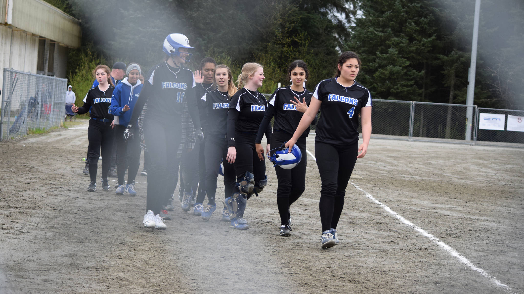 The Thunder Mountain High School softball team forms a handshake line after Saturday morning’s 8-0 win over Sitka. (Nolin Ainsworth | Juneau Empire)