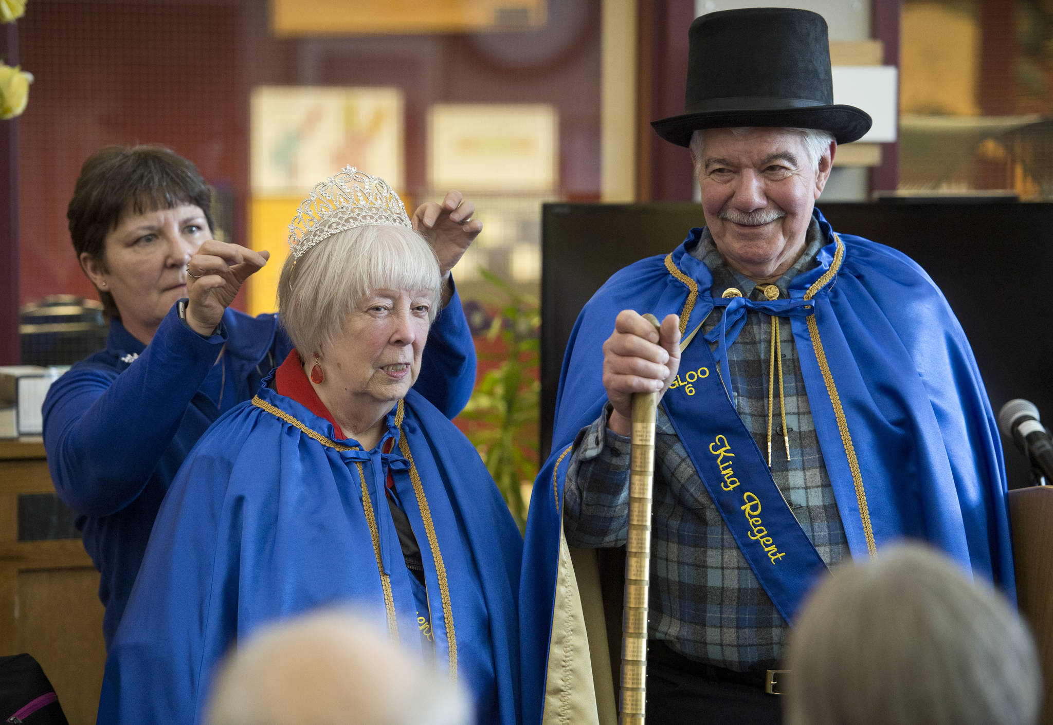 Terry and Dee Brenner are outfitted as King and Queen Regents of the Pioneers of Alaska by last year’s Queen, Carol Whelan, left, during a ceremony at the Juneau Pioneers Home on Saturday, May 13, 2017. (Michael Penn | Juneau Empire)