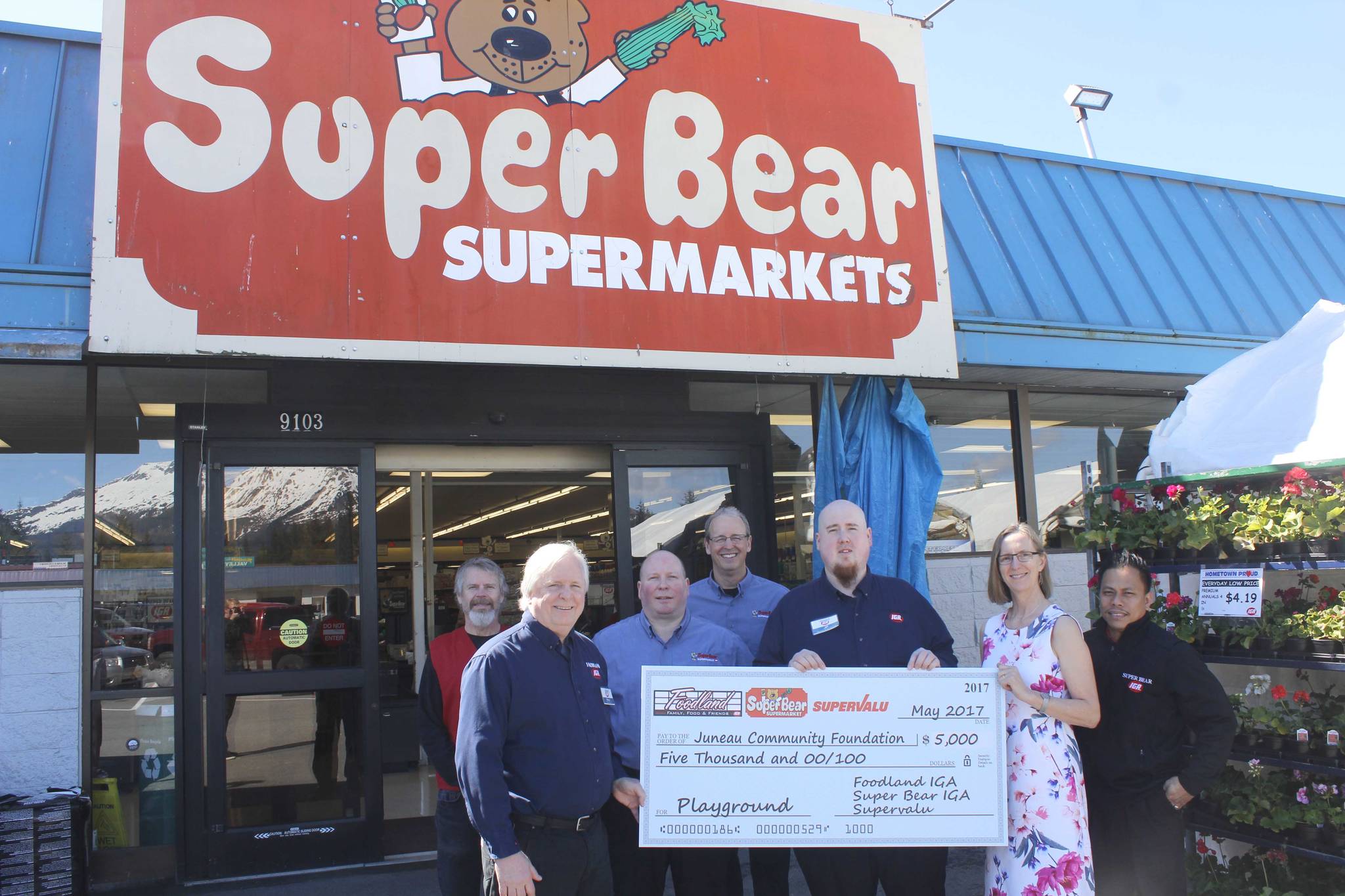 ALEX McCARTHY | JUNEAU EMPIRE Representatives from IGA, including, from left, Ace Hardware&rsquo;s Craig Good, IGA Store Manager Rick Wilson, Perishable Manager Brad Folckomer, Myers Group Director of Operations Mark Graham, Assistant Store Director JP Oudekerk and Point of Sale Manager Silver Ligsay present Juneau Community Foundation Executive Director Amy Skilbred (second from right) with a $5,000 check Monday morning to aid with the Twin Lakes Playground rebuilding effort. The Juneau Community Foundation is nearing the halfway point of its fundraising efforts, with a goal of $100,000.