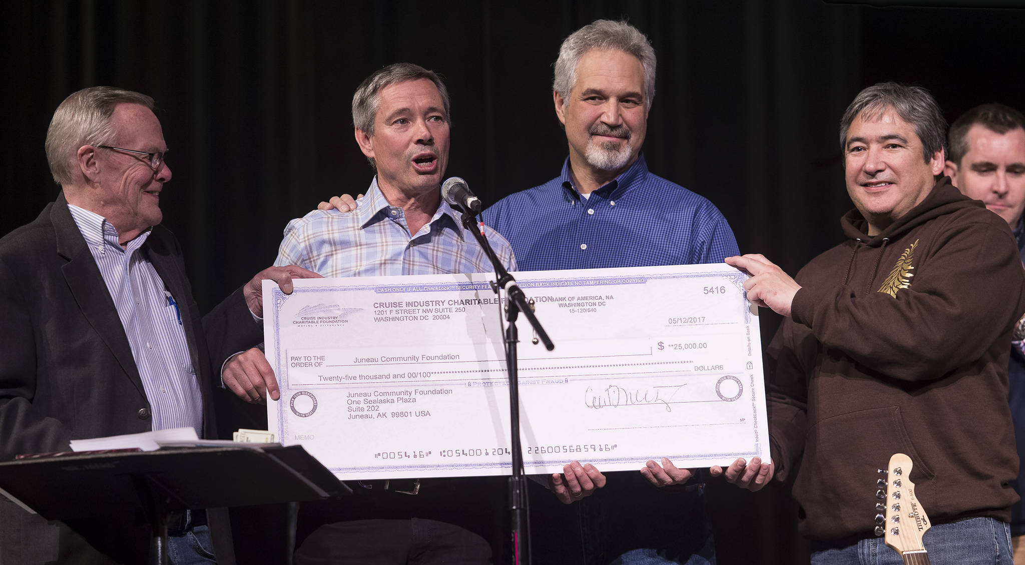 Cruise Lines International Association Alaska President John Binkley, second from left, presents a check for $25,000 to the Juneau Playground Fund from the Cruise Industry Charitable Foundation on Monday, May 15, 2017, during a fundraiser for the fire-destroyed Project Playground in Juneau, Alaska. With Binkley are Sen. Dennis Egan, D-Juneau, left, Senate President Pete Kelly, R-Fairbanks, and Rep. Sam Kito, D-Juneau, right. (Michael Penn | Juneau Empire)