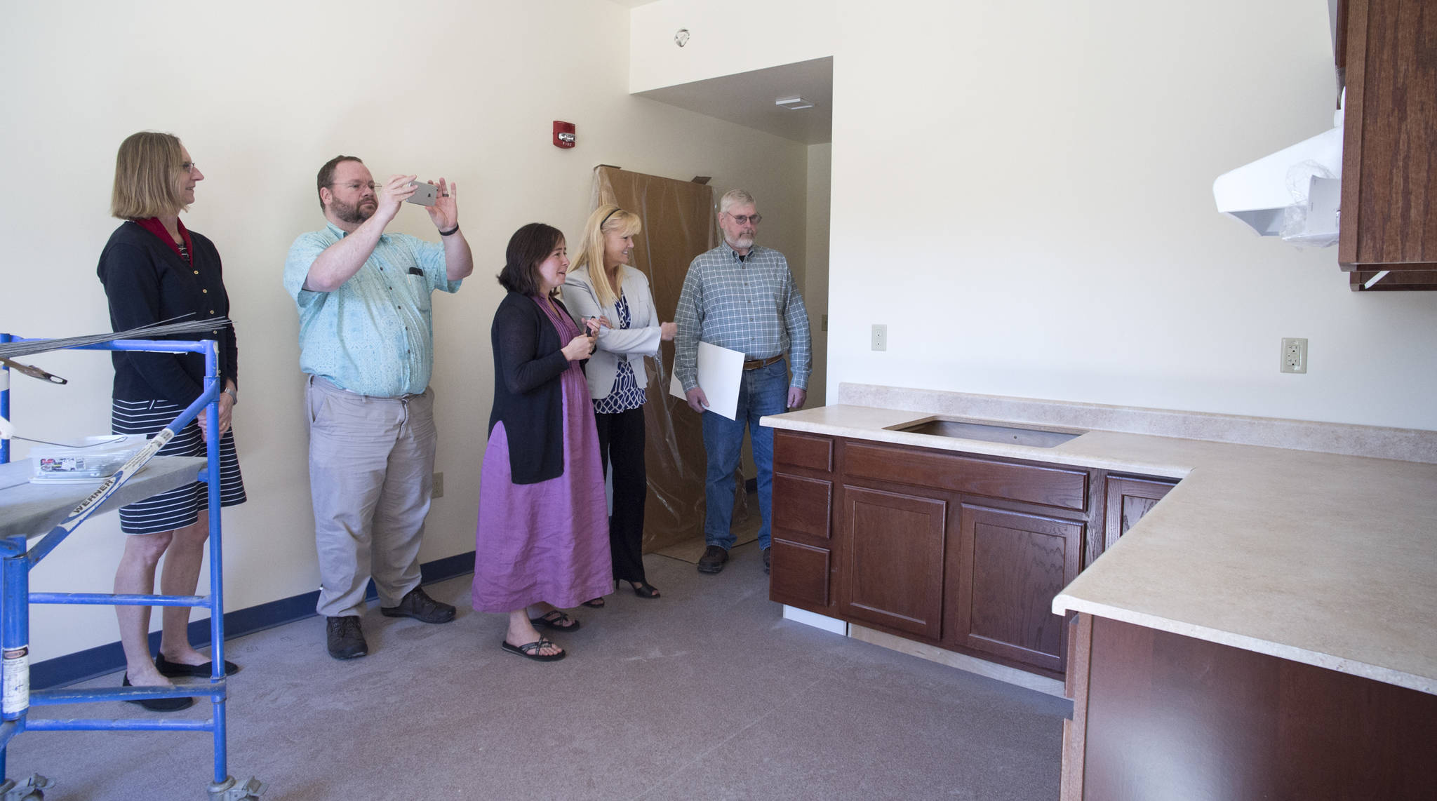 Amy Skilbred, left, Doug Harris, Chief Intergrated Services Officer of Juneau Alliance for Mental Health Inc., Mariya Lovishchuk, Executive Director of the Glory Hole, Karen West of Wells Fargo, and Steve Sorensen, board president of the Juneau Housing First Collaborative, take a tour of rooms near completion.