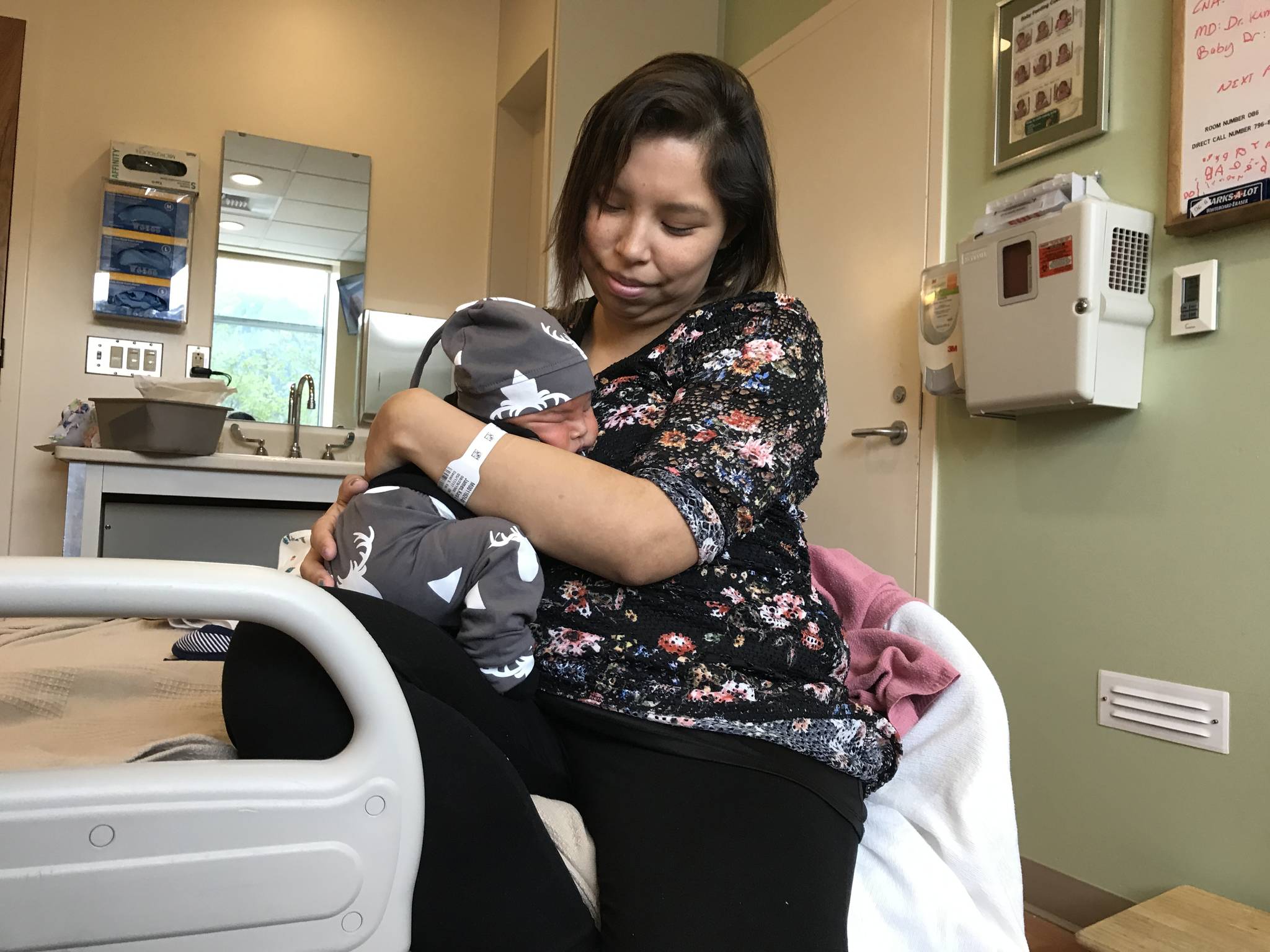 Kara James holds her newborn baby, Andrew Price Jr., at Bartlett Regional Hospital on Saturday. The day before, James received a scholarship that will allow her to attend college and pursue her goal of becoming a teacher in her hometown of Angoon. (Alex McCarthy | Juneau Empire)