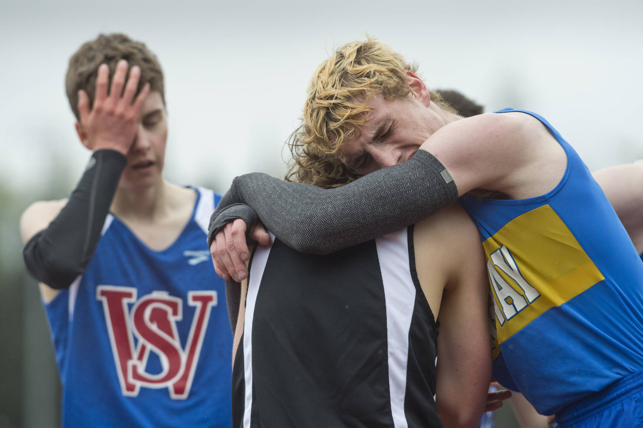 Skagway&rsquo;s Ethan Goebel, right, cries on Juneau-Douglas&rsquo; Arne Ellefson-Carnes after winning the boys 3200 meter race at the Region V Track and Field meet at Thunder Mountain High School on Friday, May 19, 2017. Ellefson-Carnes took third and Sitka&rsquo;s Colin Baciocco, left, took fifth. (Michael Penn | Juneau Empire)