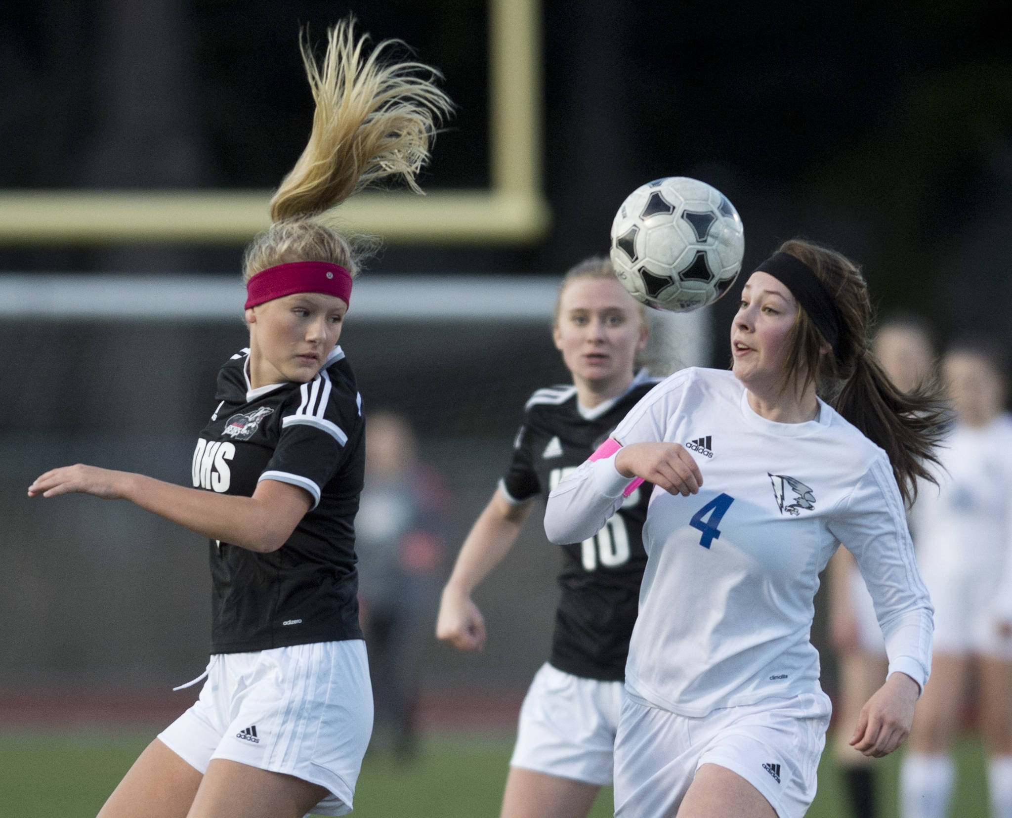 Juneau-Douglas&rsquo; Michaela Bentley, left, competes with Thunder Mountain&rsquo;s Azure Briggs for the ball during their match at TMHS on Tuesday, April 11, 2017. Juneau-Douglas won 1-0. (Michael Penn | Juneau Empire)