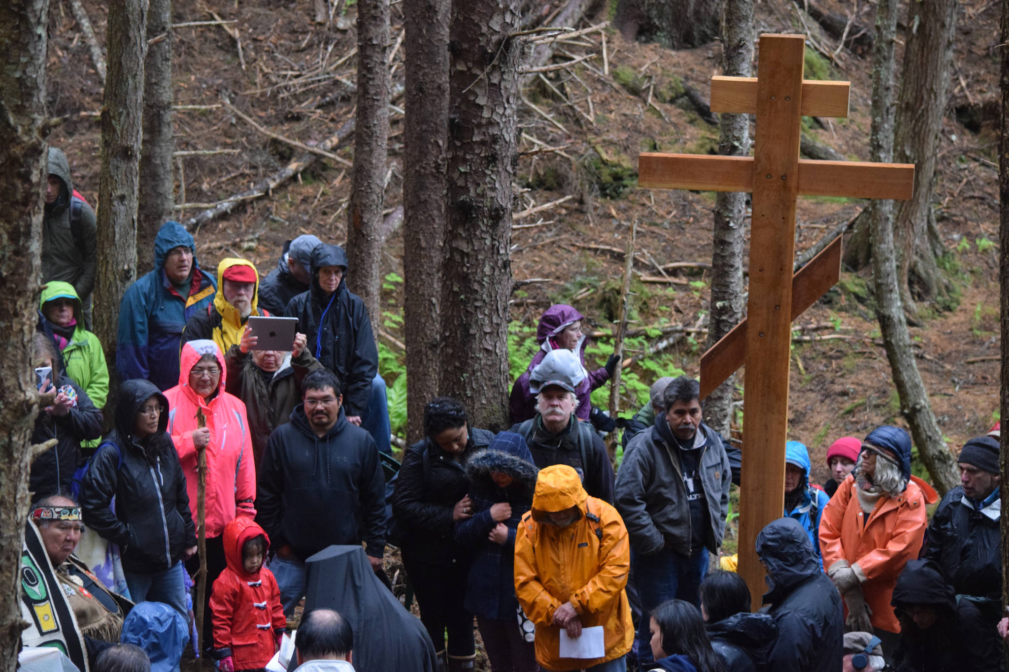 Survivors, friends and family visit the Funter Bay internment camp where of hundreds of Aleutian and Pribiloff Island Alaska Natives were held during WWII. Commemorating the 75th anniversary of the internment, the group installed a “healing cross” at the grave site of those who perished during their years of internment. (Kevin Gullufsen | Juneau Empire)
