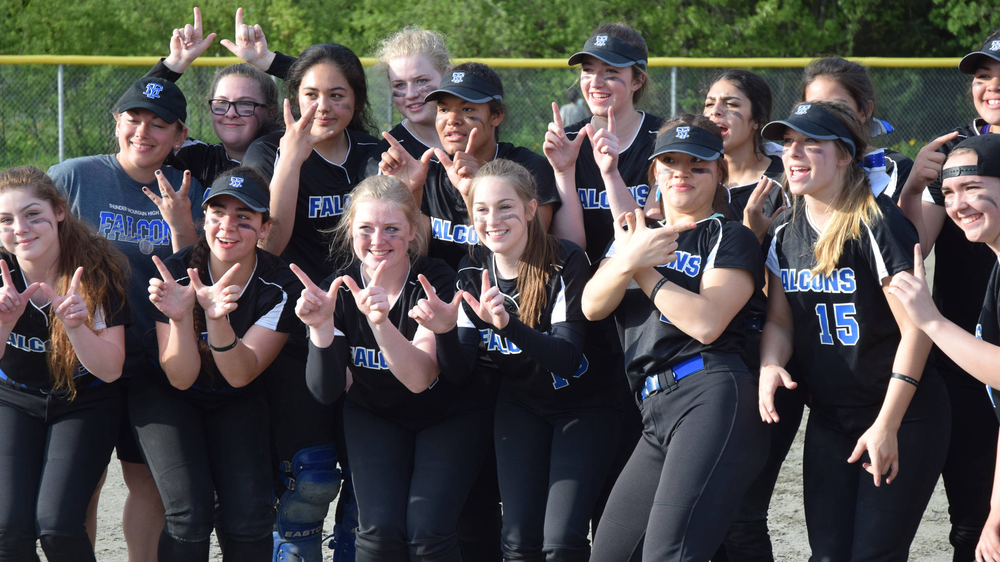 The Thunder Mountain High School softball team hams it up for the camera after winning the Region V softball championship with a 17-11 win over Juneau-Douglas High School, Saturday, May 27, 2017, at Melvin Park. (Nolin Ainsworth | Juneau Empire)