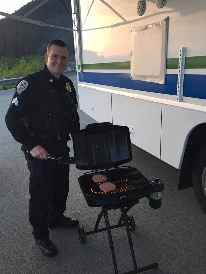 Juneau Police Department Sgt. Shawn Phelps grilling up some burgers at the mobile command post, which was set up at Eagle Beach over Memorial Day weekend for added enforcement. (Photo courtesy of the Juneau Police Department)