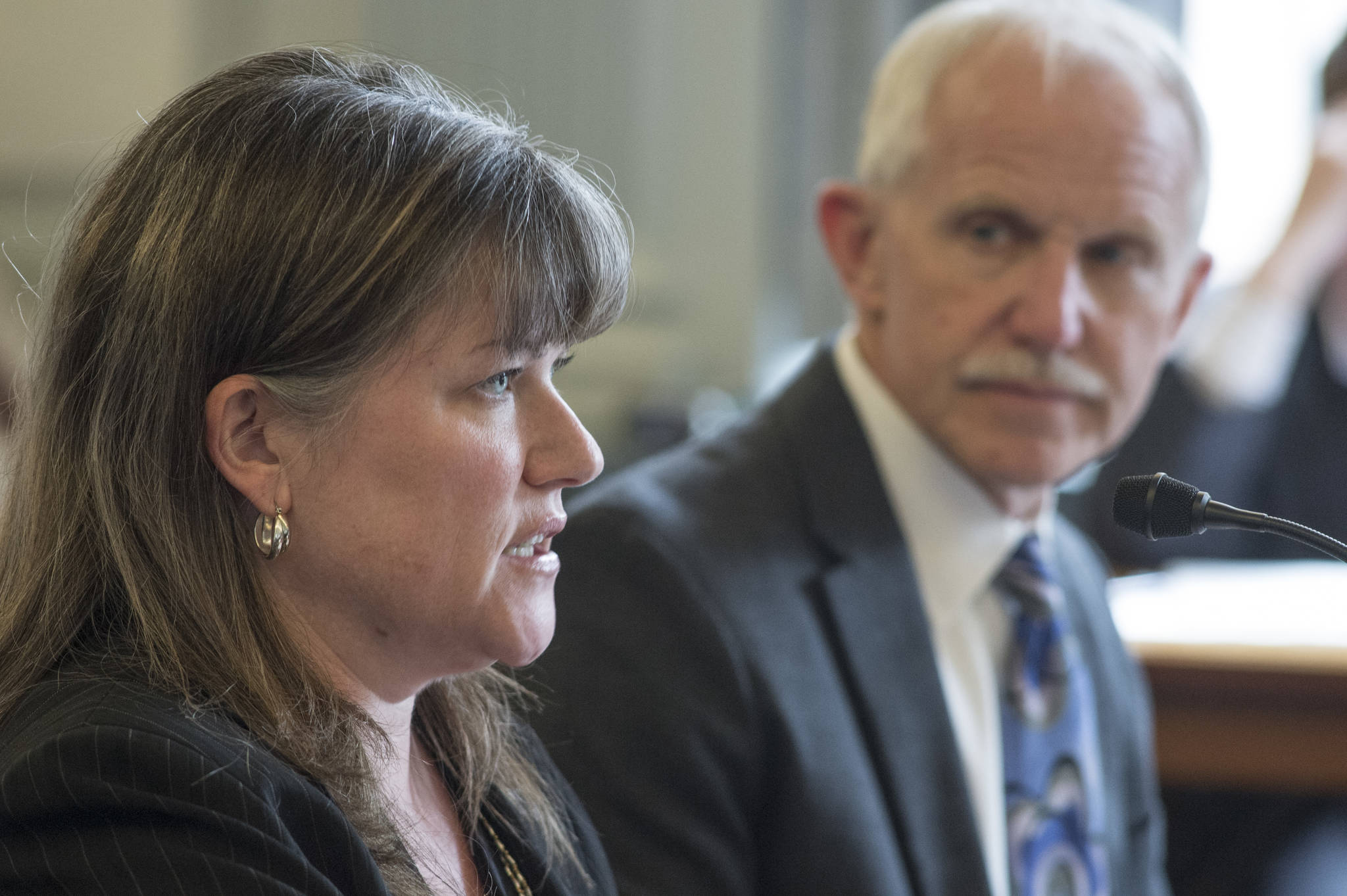 Sara Chambers, Deputy Director of the Division of Corporations, Business and Professional Licensing at the Department of Commerce, Community and Economic Development, left, and Dr. Jay C. Butler, Chief Medical Officer for the Alaska Department of Health and Social Services, speak about an opioids bill in front of the Senate Finance Committee at the Capitol on Tuesday, May 30, 2017. (Michael Penn | Juneau Empire)