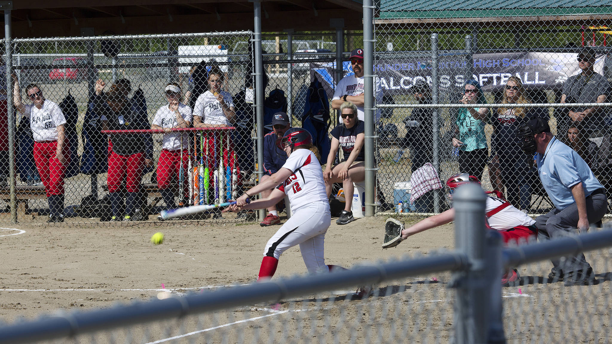 Morgan Balovich hits the ball to centerfield against North Pole, Friday, June 2, at the ASAA/First National Bank Alaska State Softball Championships in Fairbanks. (Sarah Manriquez | For the Juneau Empire)