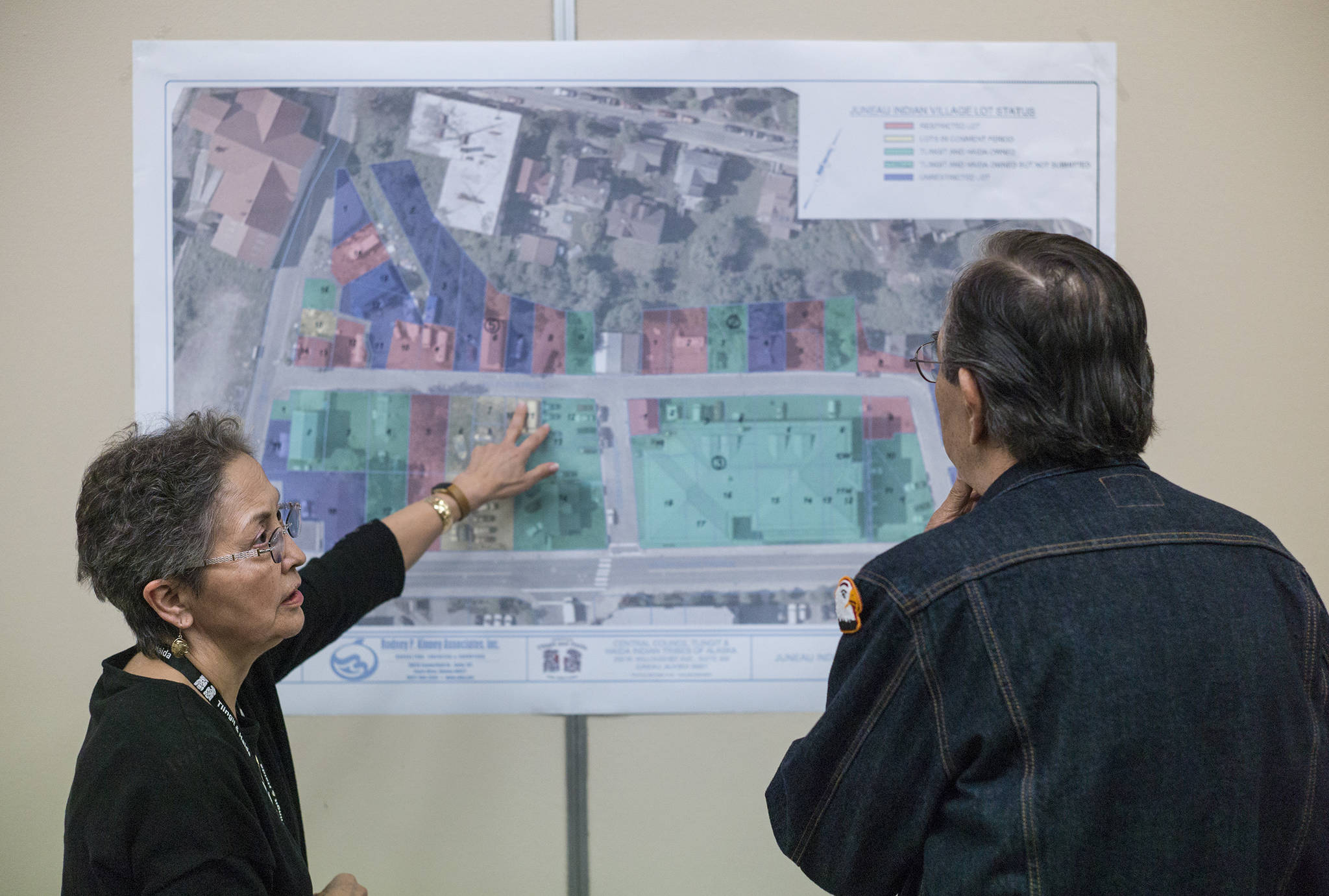 Corrine Garza, Chief Operating Officer Tribal Operations of Central Council of the Tlingit and Haida Indian Tribes of Alaska, explains a map of the Juneau Indian Village to Melvin Ward during a public meeting at the Elizabeth Peratrovich Hall on Wednesday, May 31, 2017. The Tlingit & Haida open house discussed Tlingit & Haida’s land into trust applications and provided an explanation on what Indian trust status is and can provide. (Michael Penn | Juneau Empire)