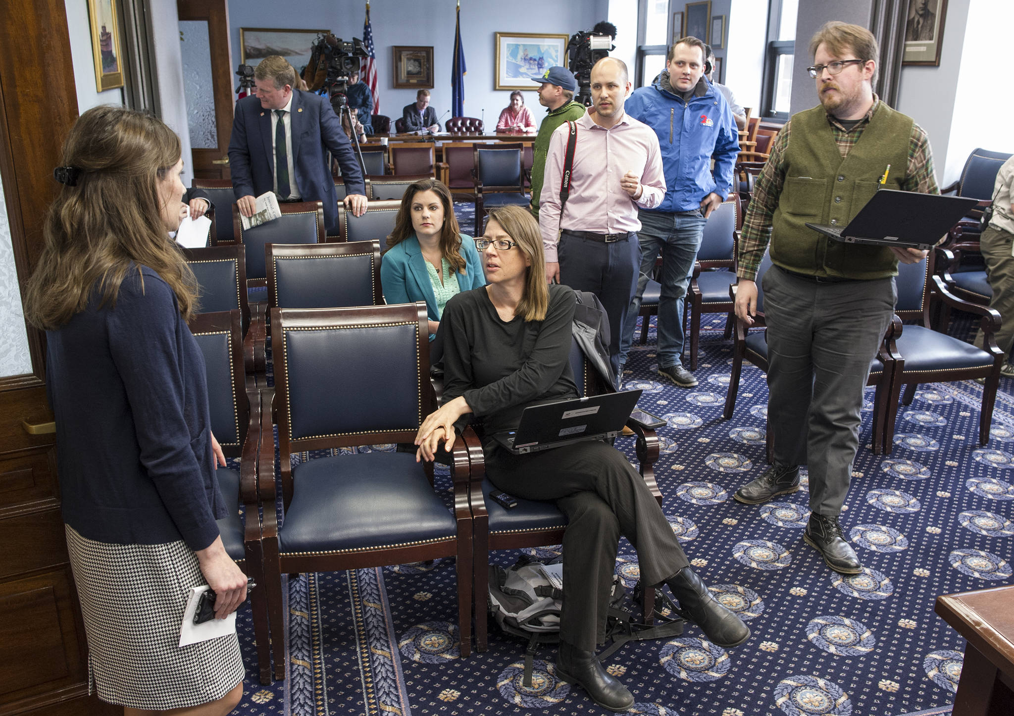 Rena Miller, communications director for the Senate Majority Caucus, left, tells Alaska reporters that a press conference called by the Caucus has been cancelled at the Capitol on Friday, June 2, 2017. (Michael Penn | Juneau Empire)