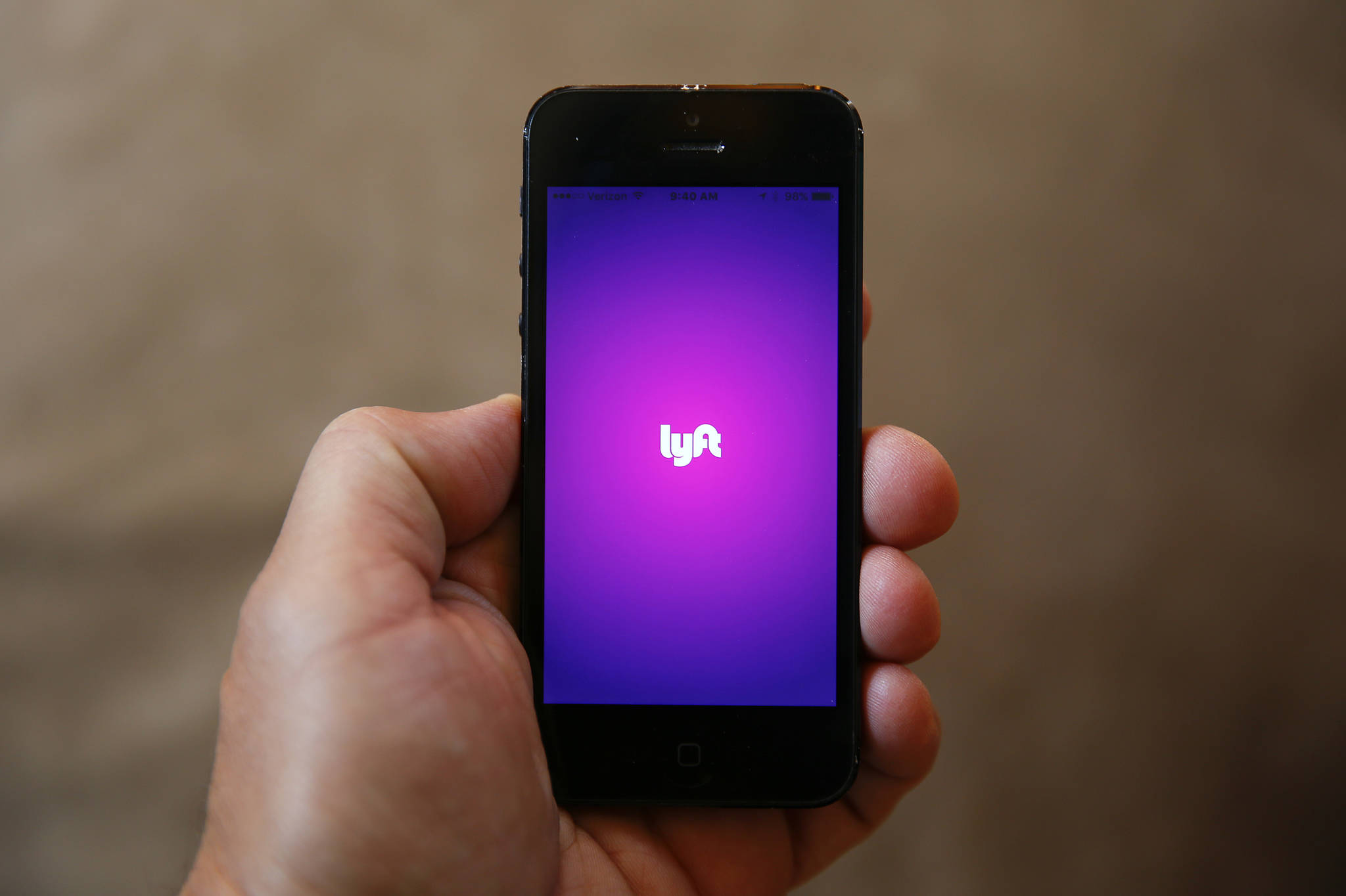 This May 16, 2016 file photo shows a smartphone displaying the Lyft app in Detroit. (Paul Sancya | The Associated Press File)