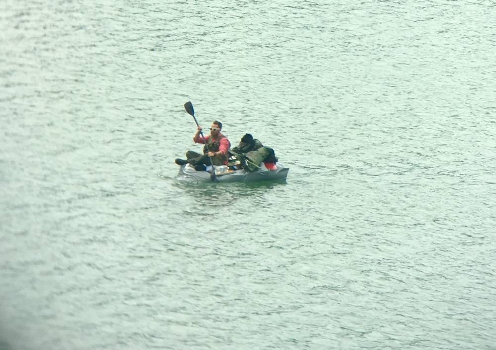 A man paddles a homemade watercraft in the Gastineau Channel, near Juneau, Alaska, June 7, 2017. A Coast Guard Station Juneau smallboat crew rescued a 32-year-old man after the craft began taking on water. (Courtesy Photo | U.S. Coast Guard)