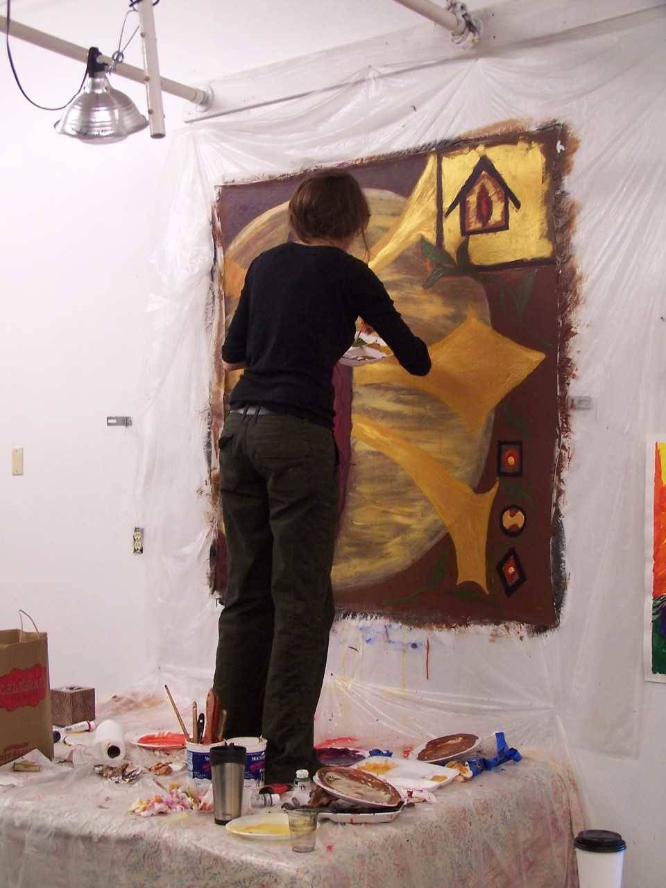 A woman works on a painting at one of Cynthia Schildhauer’s workshops. (Photo courtesy Meghan Chambers)