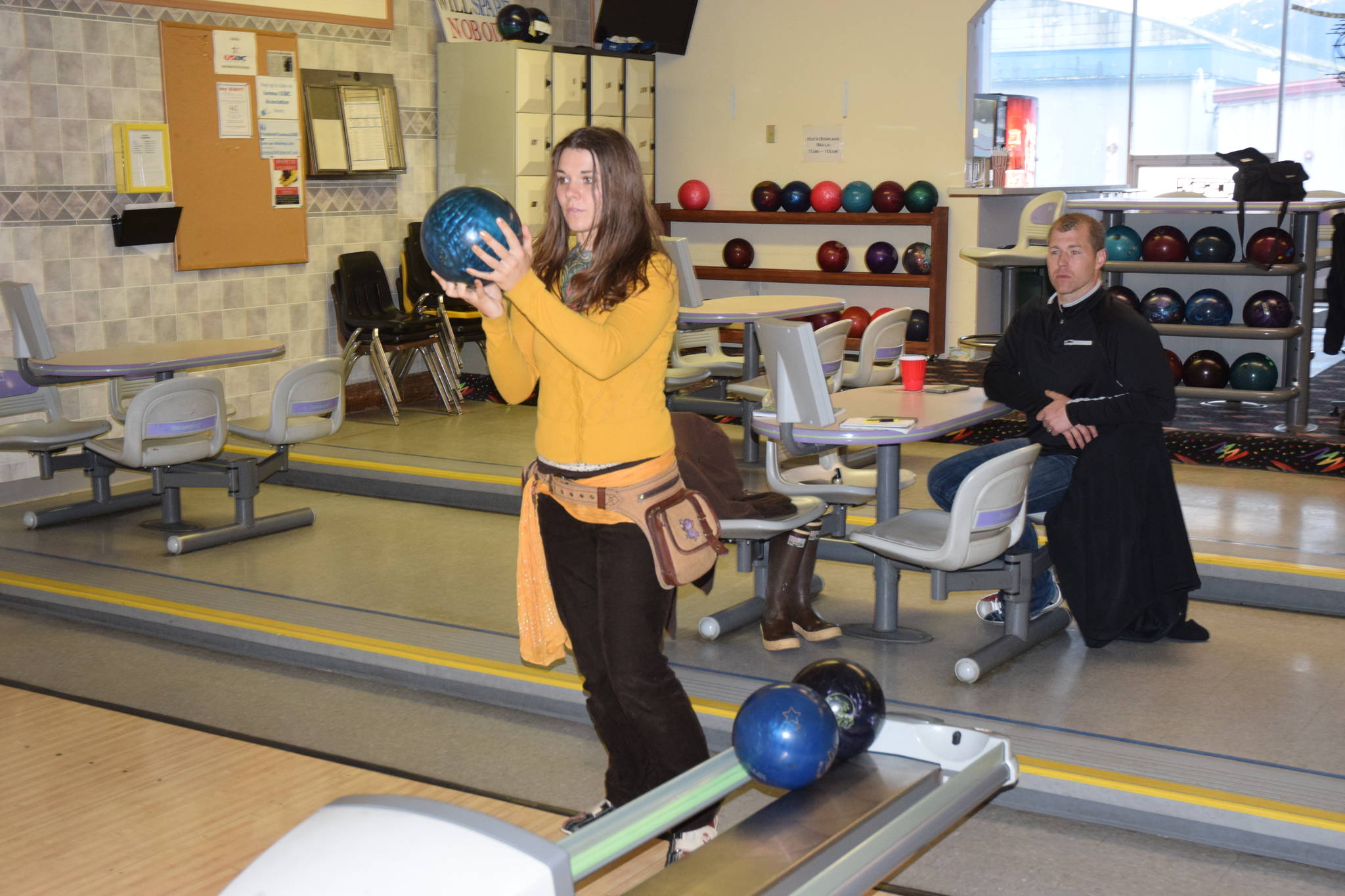 Rebecca Bells readies a shot while bowling with Juneau Police Department officer Krag Campbell at Taku Lanes on Saturday. (Kevin Gullufsen | Juneau Empire)