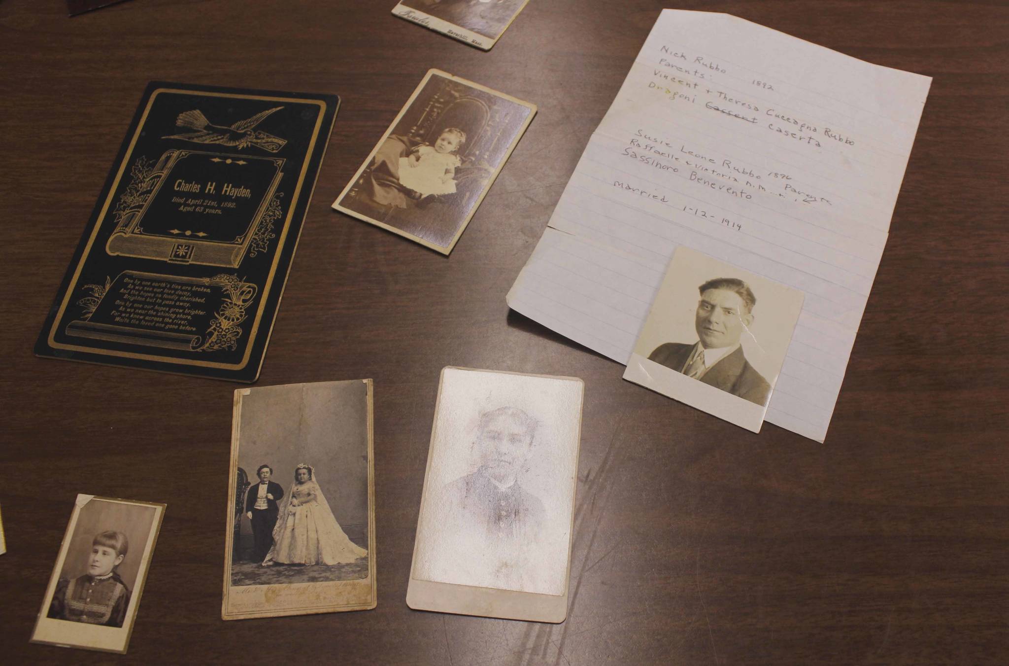 Generations-old photos lie on the table at the Gastineau Genealogical Society’s Family History Center. The photos were anonymously donated to the Friends of the Libraries. (Alex McCarthy | Juneau Empire)