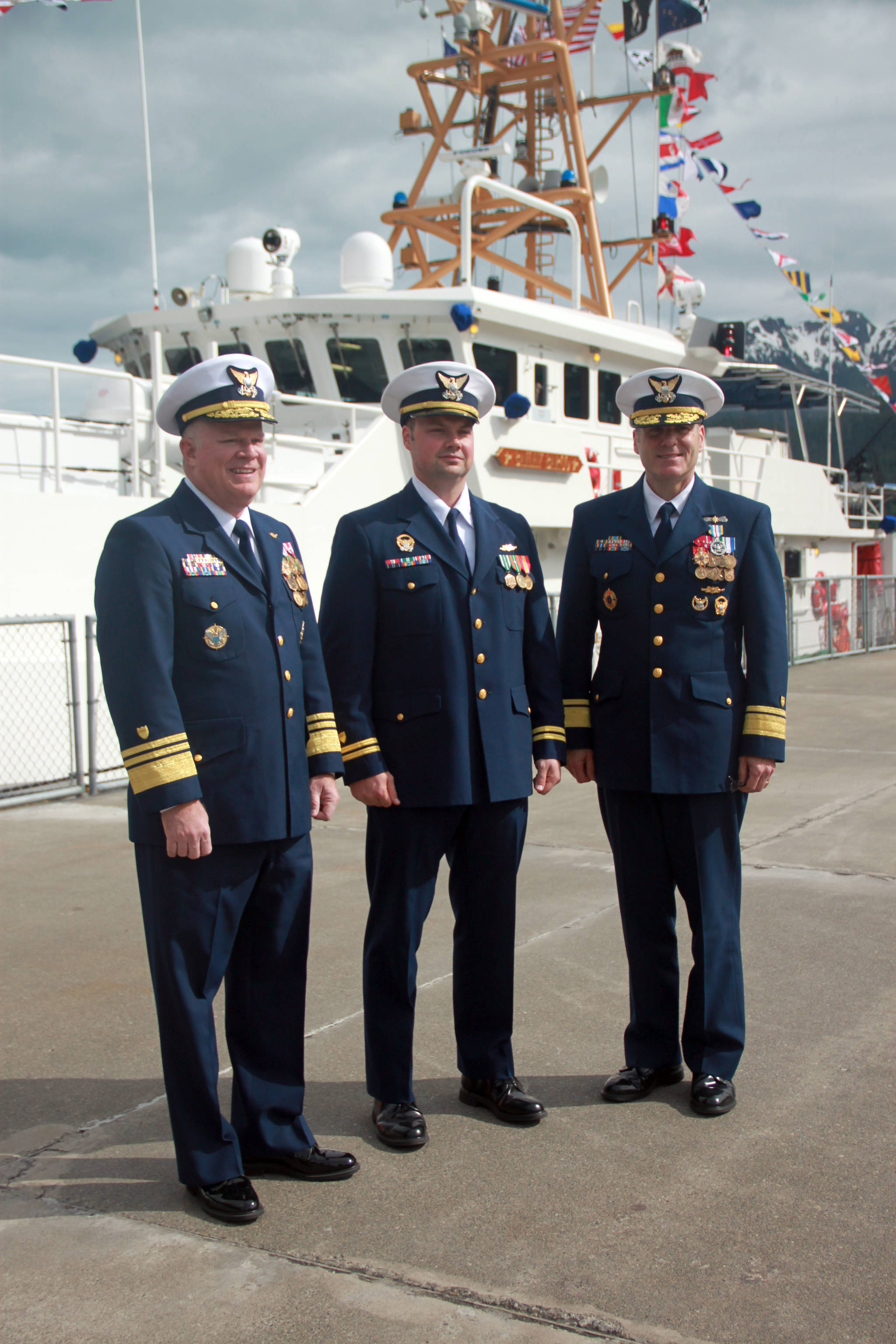 (From left to right) Vice Admiral Fred Midgette, commander of the Coast Guard pacific area, Lieutenant Frank Reed, commanding officer of the USCGC Bailey Barco, and Rear Admiral Michael McAllister, commander of the 17th coast guard district, stand in front of the newly commissioned coast guard cutter, Bailey Barco, following the commissioning ceremony Wednesday afternoon. (Erin Granger | Juneau Empire)